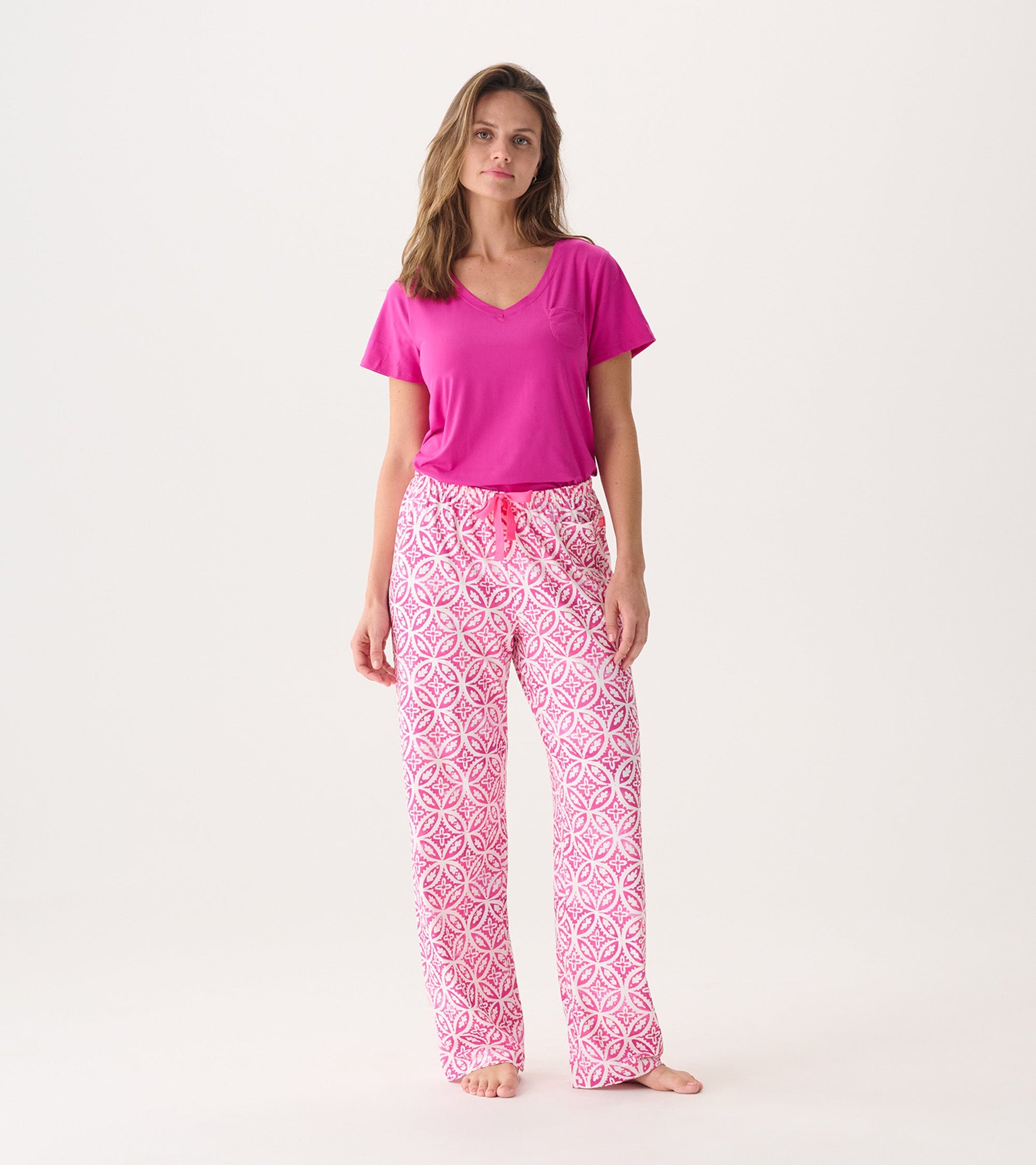 Women's pink pajama pants with a lotus mandala pattern, featuring a drawstring waist and relaxed fit.