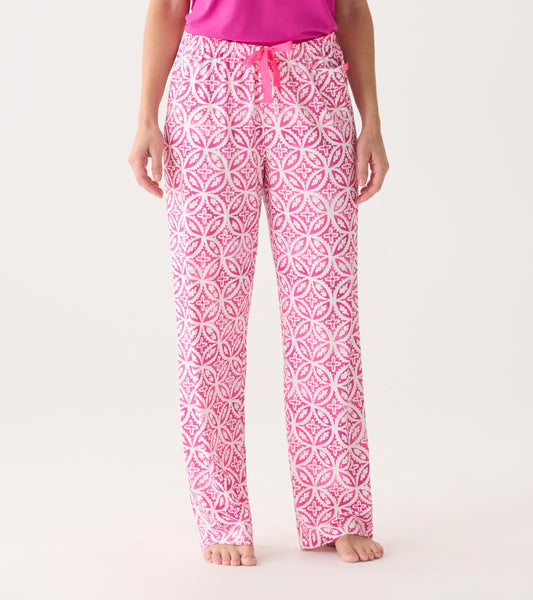 Women's pink pajama pants featuring a lotus mandala pattern, made from soft polyknit fabric, with an elastic waistband.