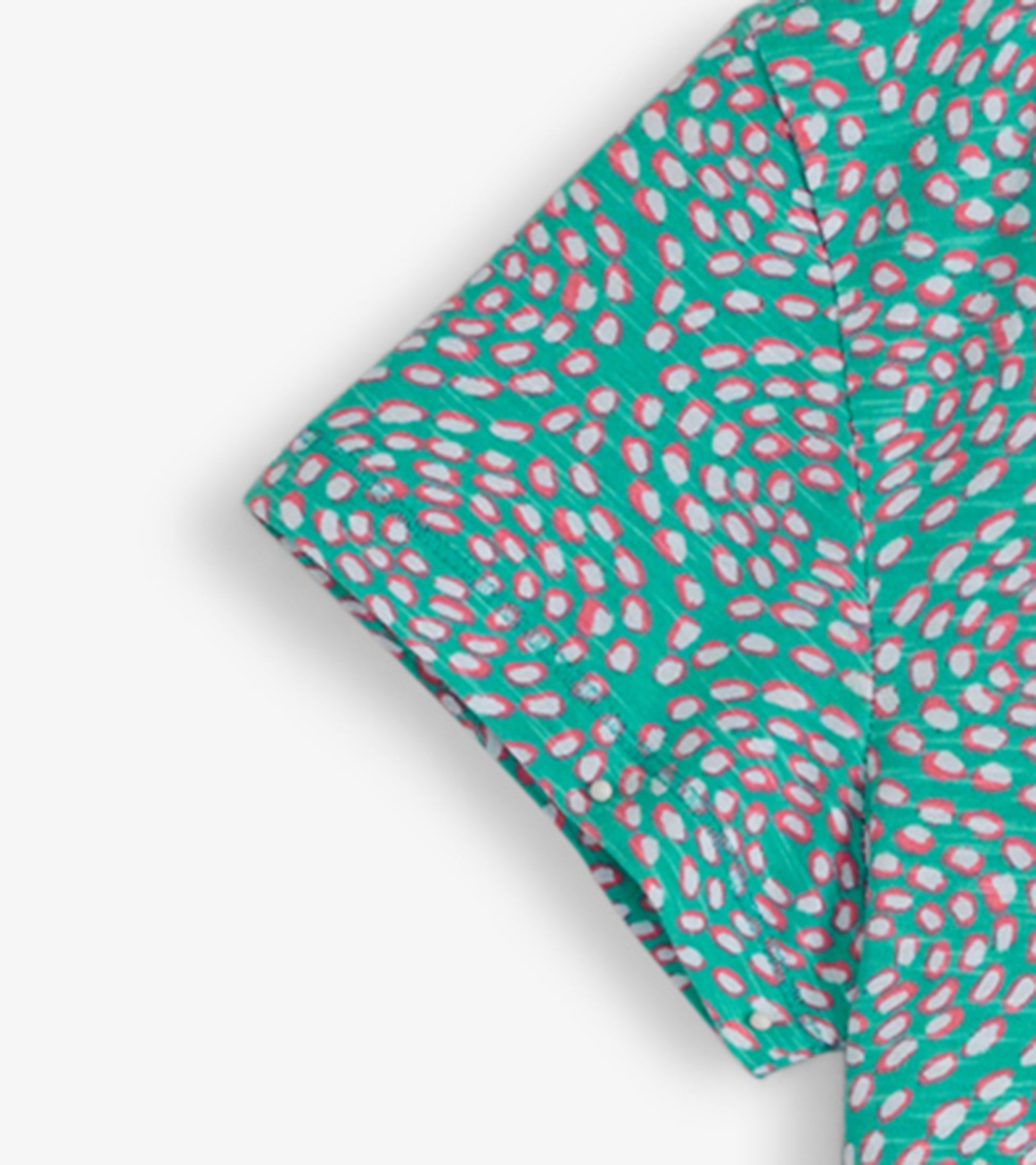 Turquoise crew neck t-shirt dress with a playful pink and white spotted pattern, short sleeves, and a relaxed fit.