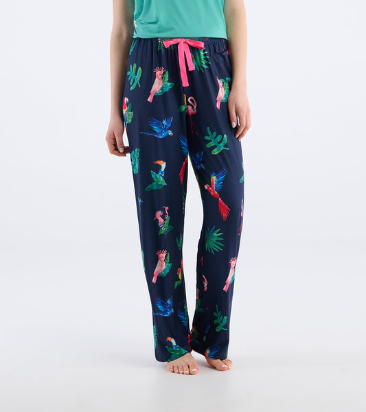 Navy pajama pants featuring a colorful tropical bird and foliage print, with a pink drawstring waist.