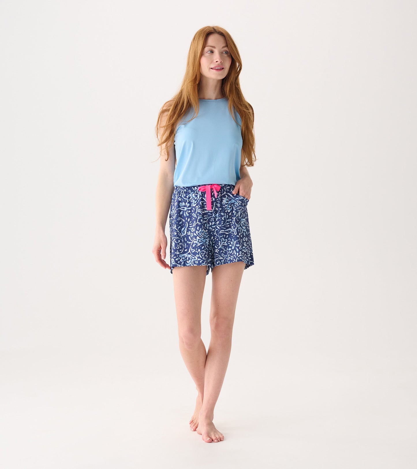Light blue sleeveless top paired with navy batik floral print pajama shorts featuring a pink drawstring.