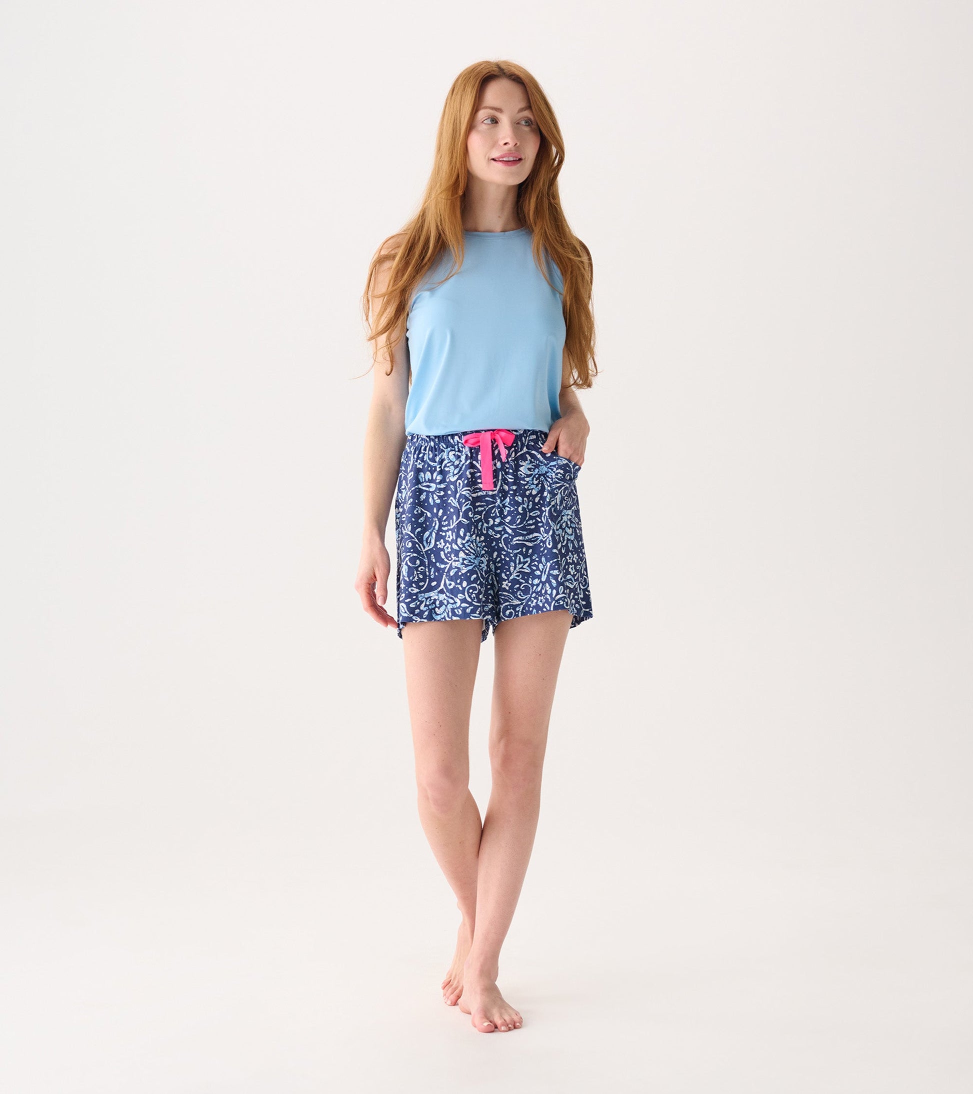 Light blue sleeveless top paired with navy batik floral print pajama shorts featuring a pink drawstring.