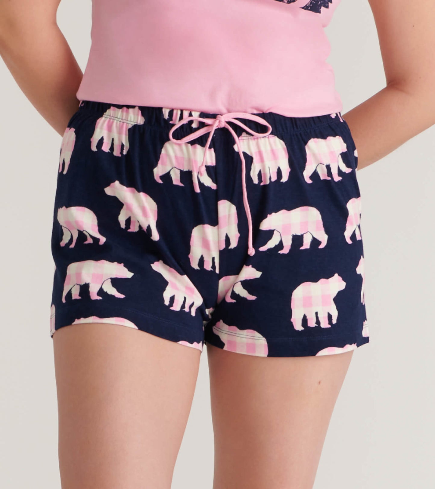 Navy cotton sleep shorts featuring a playful pink bear pattern and an elastic waistband with a drawstring.
