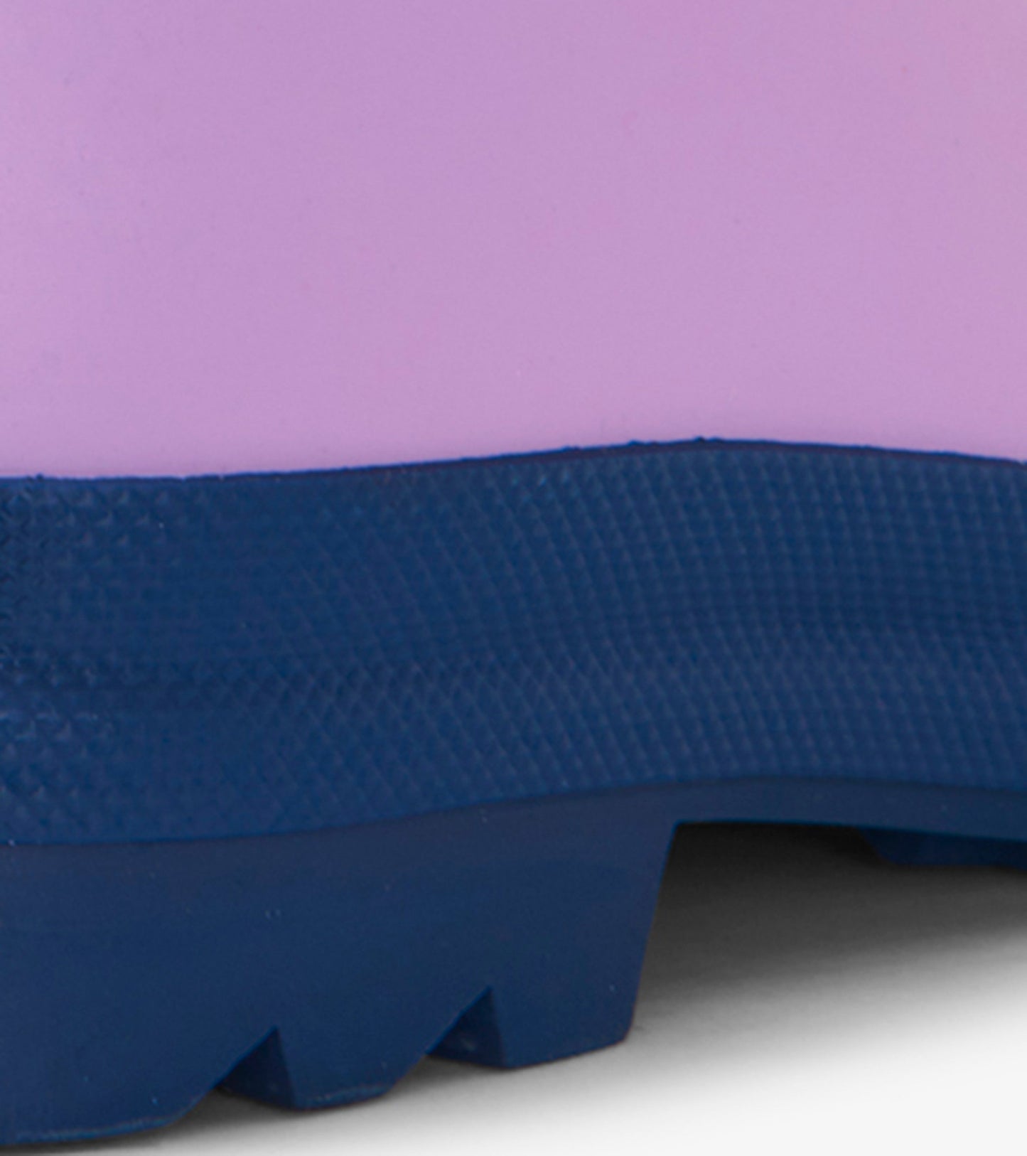Lilac matte rain boots with a navy sole, featuring a textured surface and a sturdy design for kids.