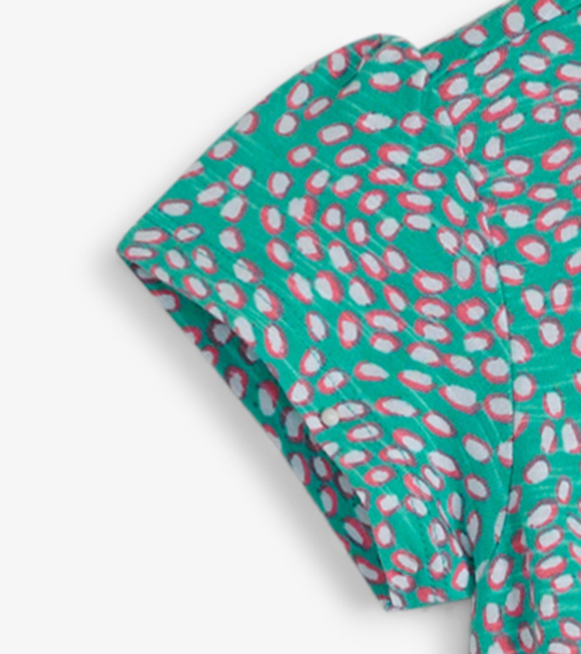 Turquoise t-shirt dress with a playful pink and white oval pattern, featuring short sleeves and a relaxed fit.