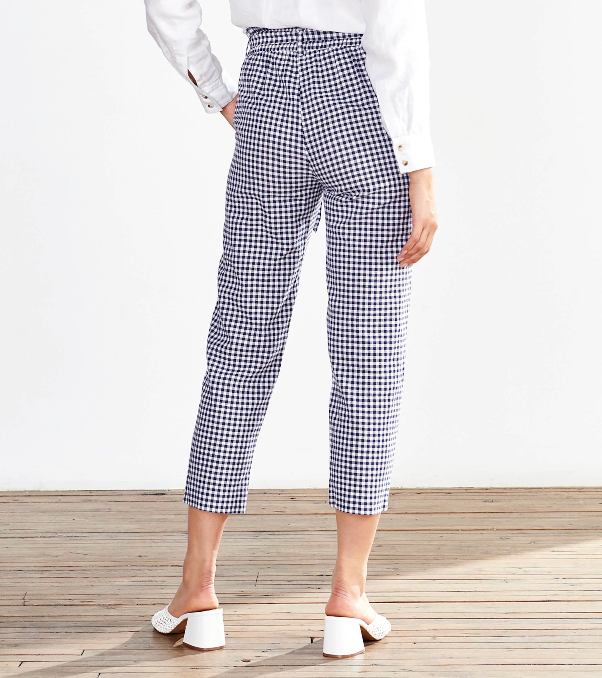 Navy gingham paper bag pants with a relaxed fit and cropped length, featuring a gathered waistband.