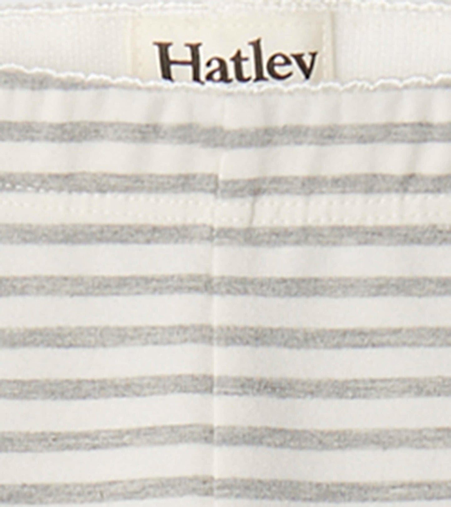Light gray and white striped leggings with an elastic waistband, suitable for casual wear.