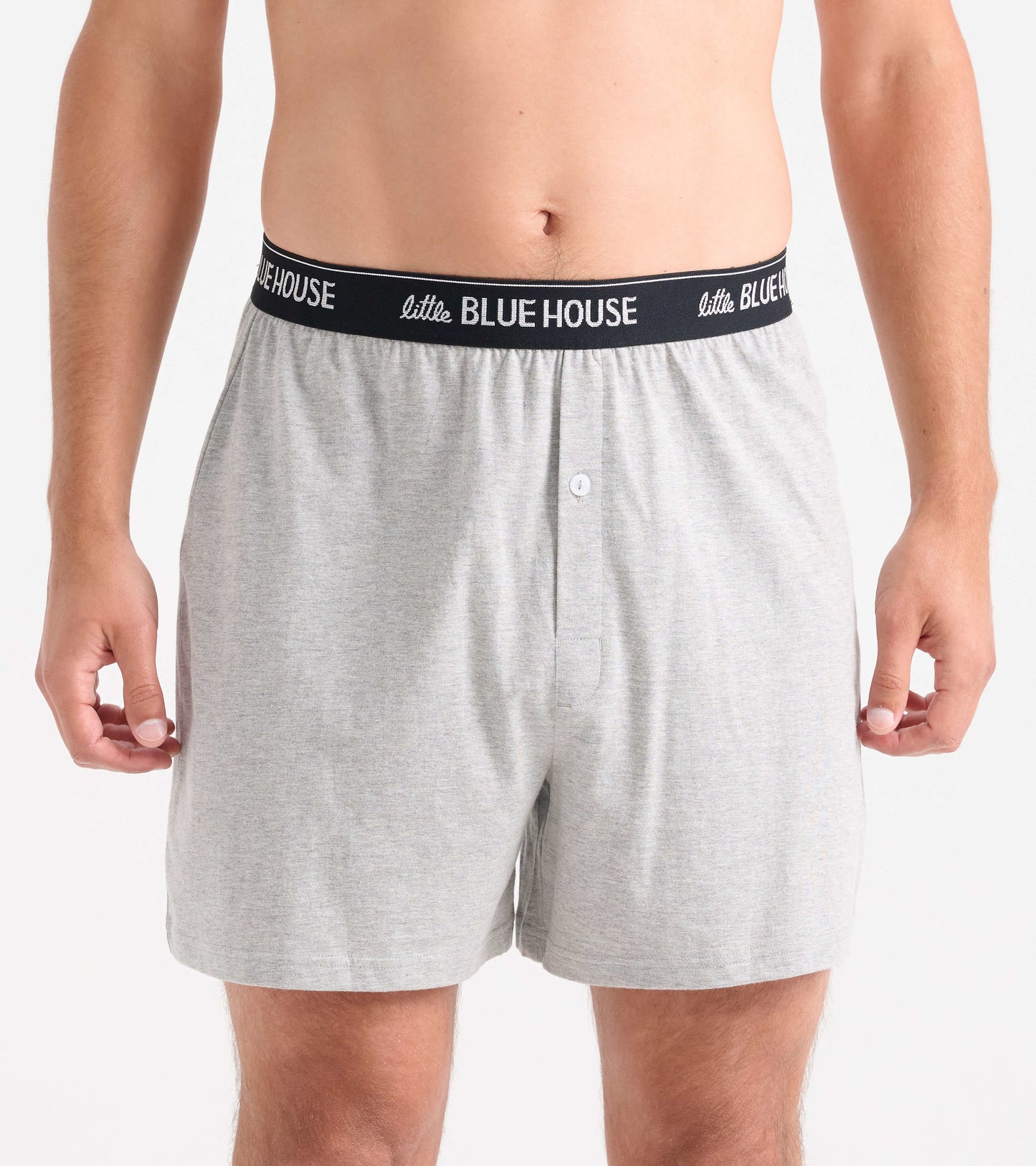Gray men's boxer shorts with a black elastic waistband, featuring a button fly and a relaxed fit.