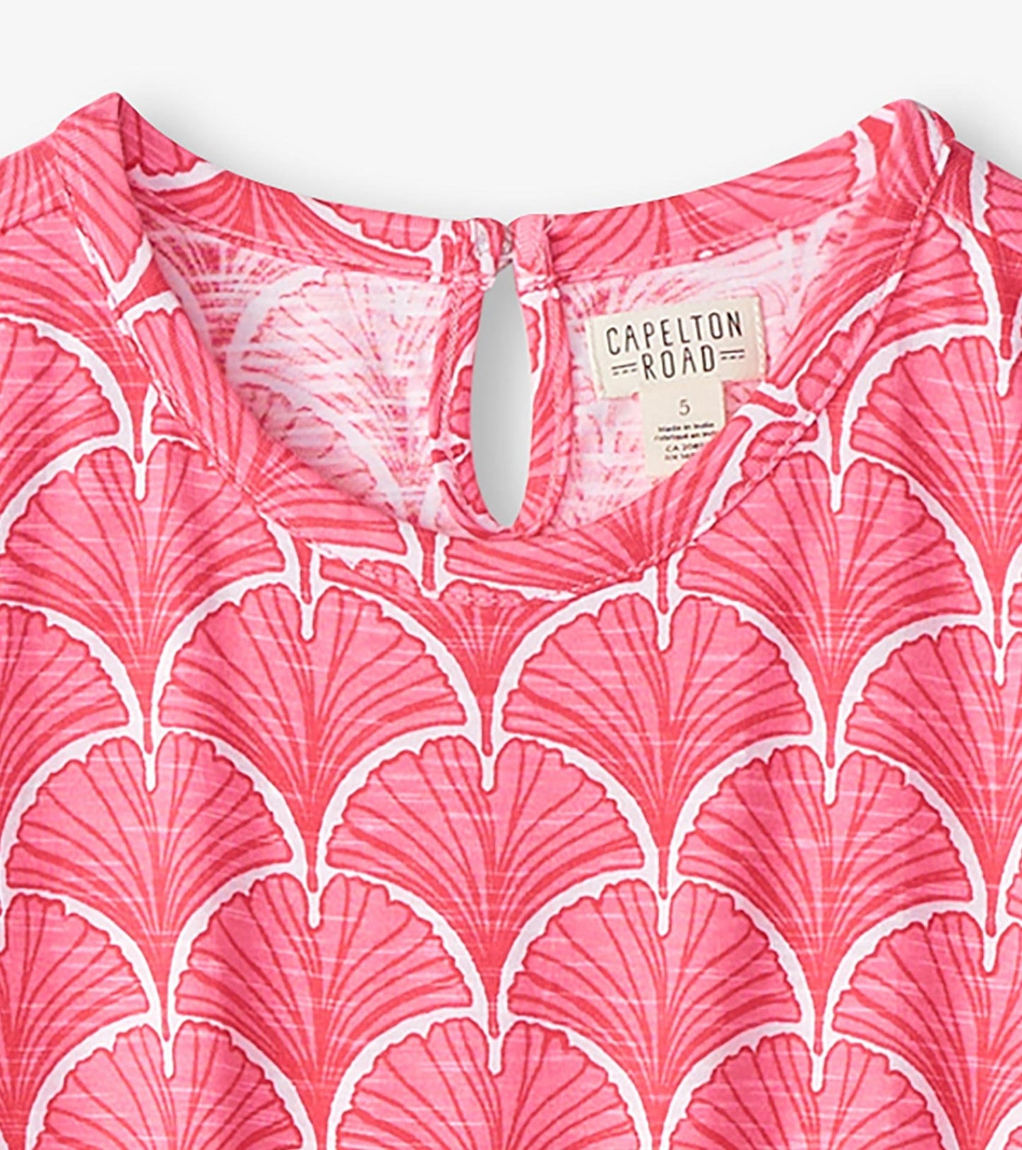 Coral T-shirt dress featuring a fan pattern, with a keyhole back detail and soft fabric. Suitable for casual wear.