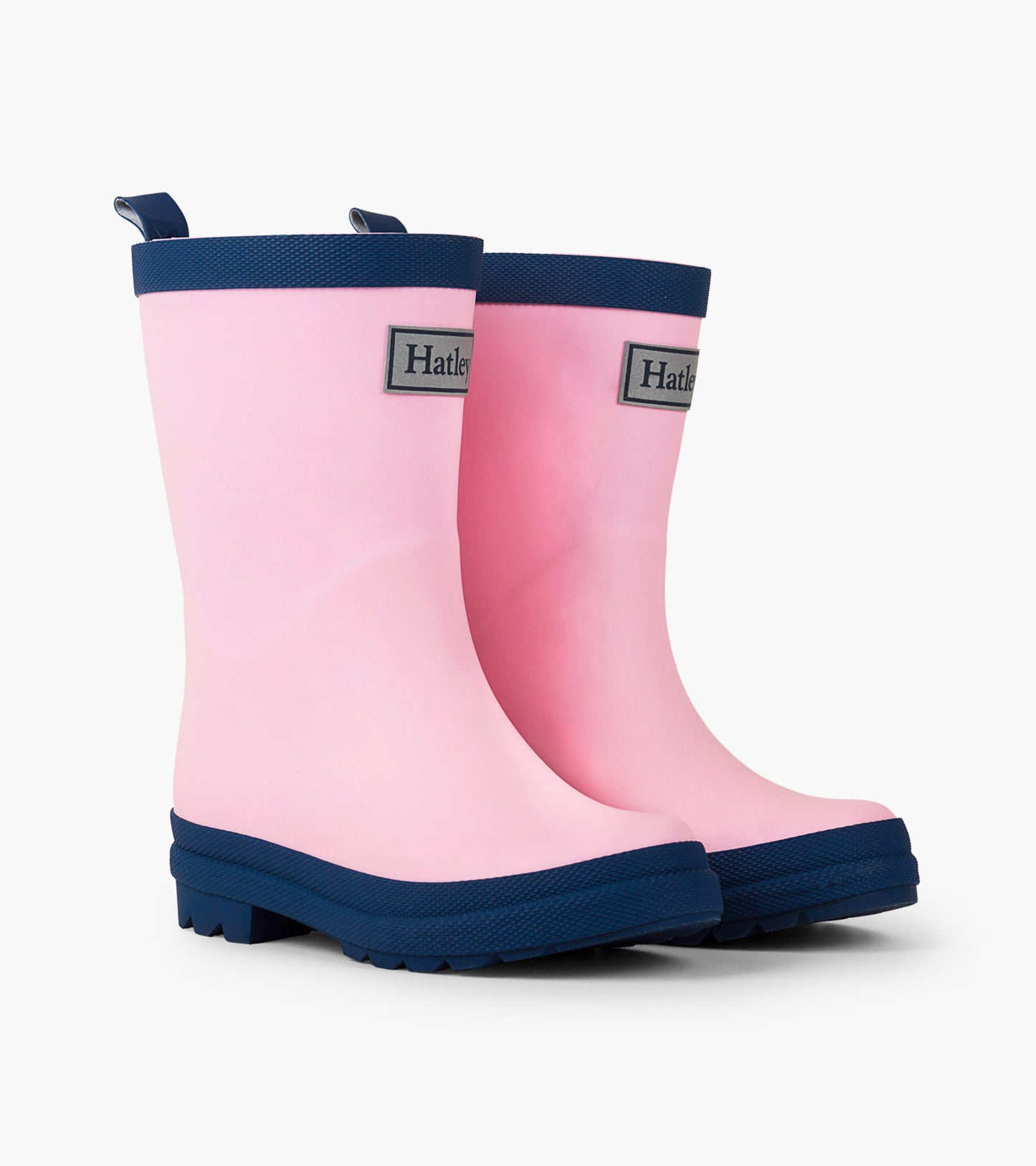 Kids' matte rain boots in pink with navy accents, featuring a sturdy sole and pull tabs for easy wear.