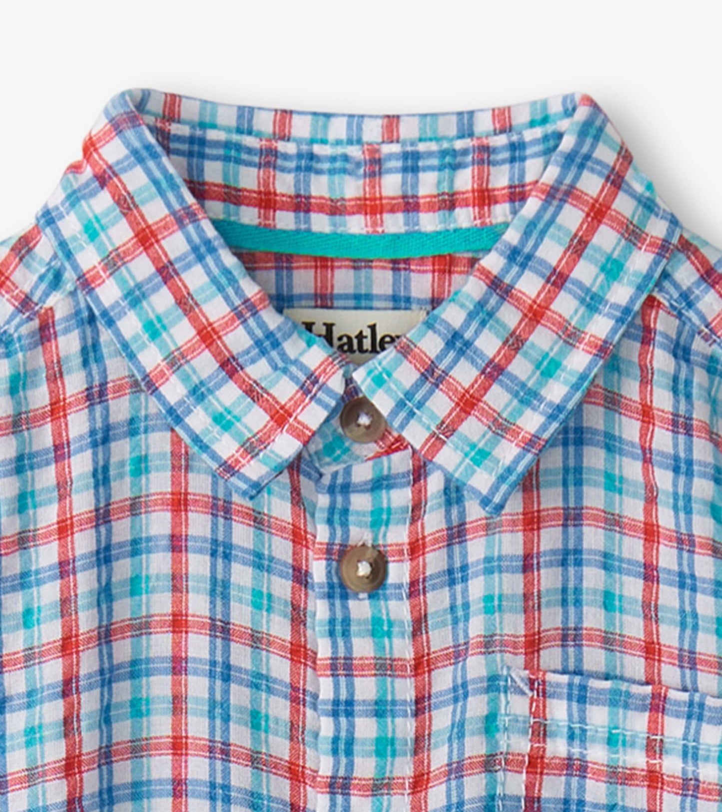 Colorful plaid button-down shirt featuring red, blue, and turquoise patterns with a collar and chest pocket.