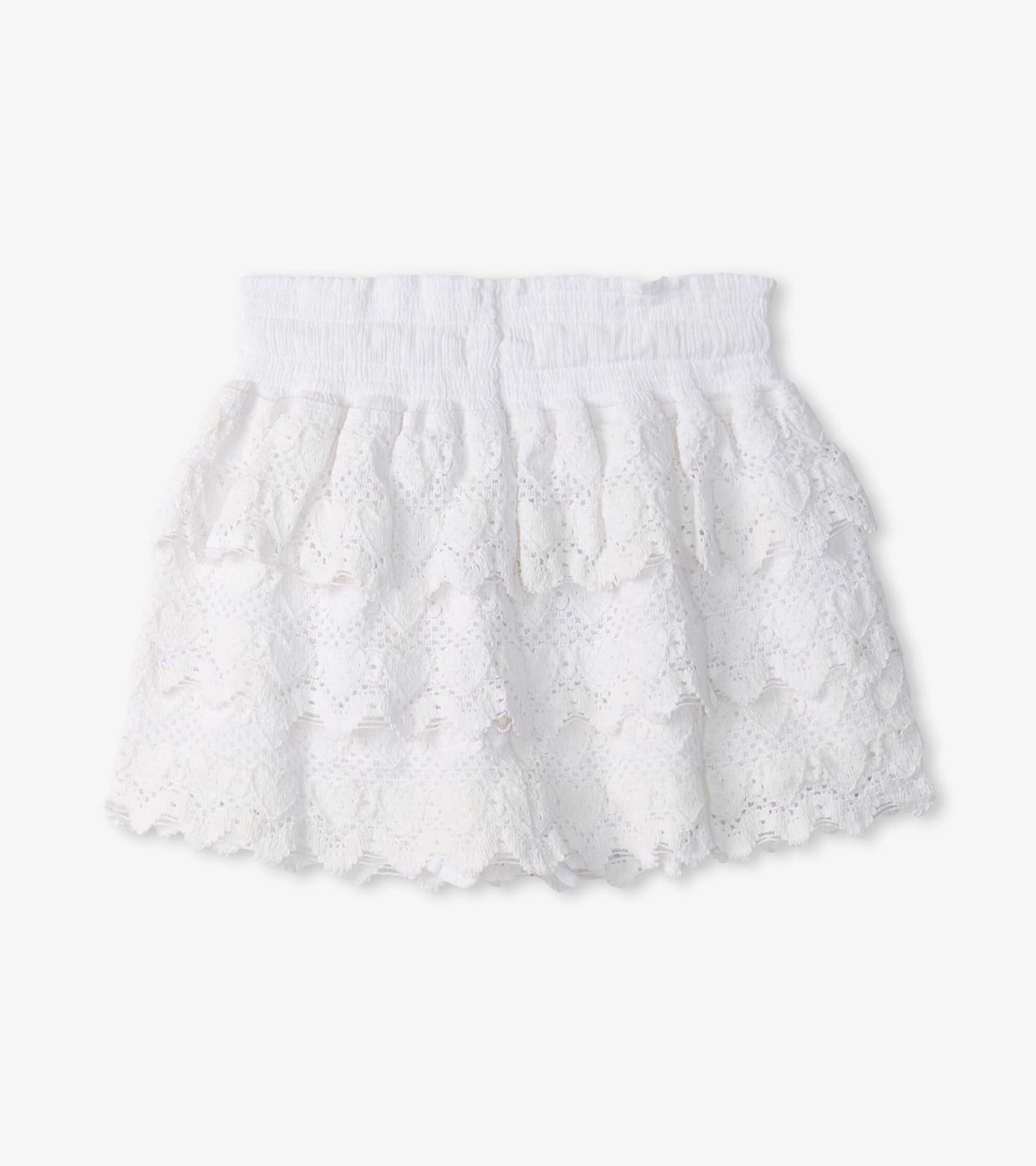 White floaty skort with layered ruffles and heart patterns, featuring an elastic waistband for comfort.