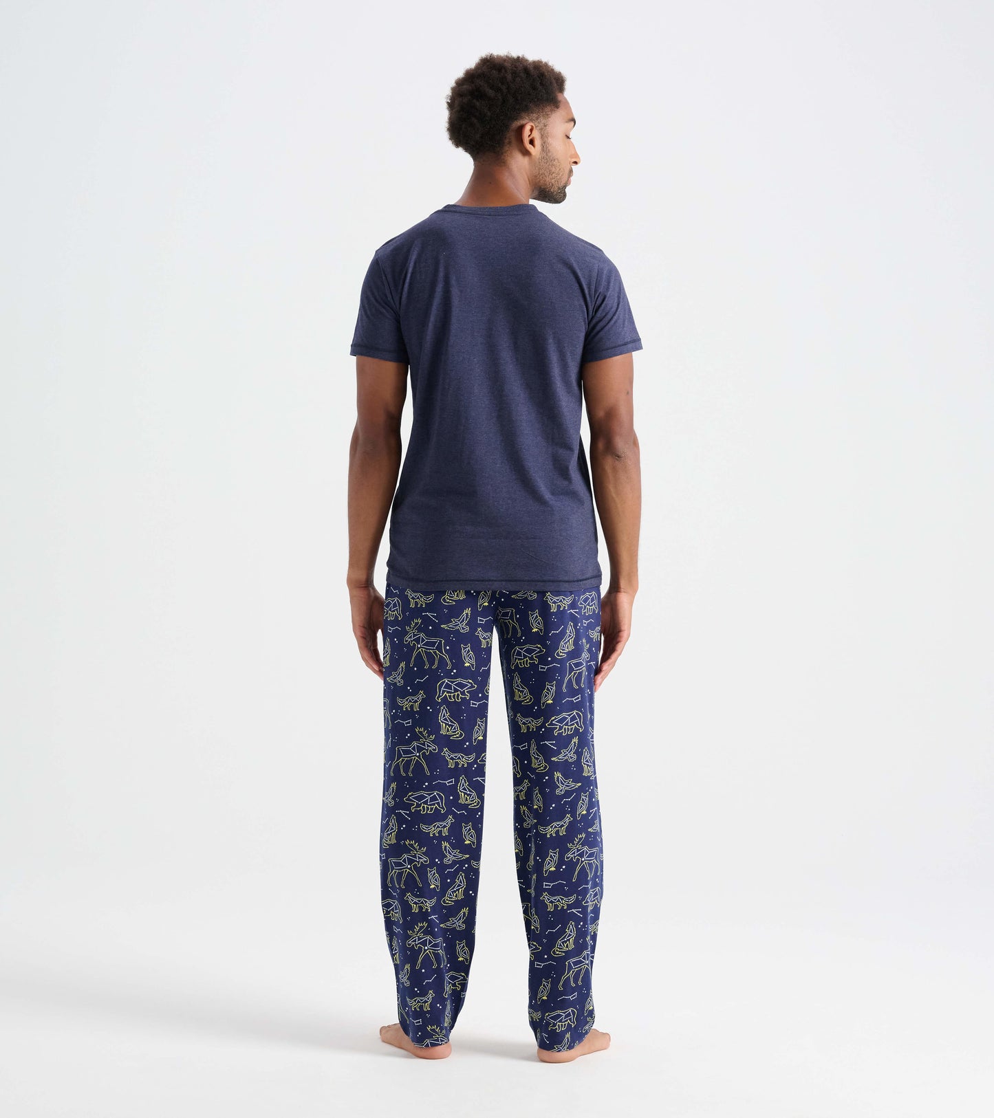 Navy cotton pajama pants featuring animal constellations in a light green pattern, shown from the back.