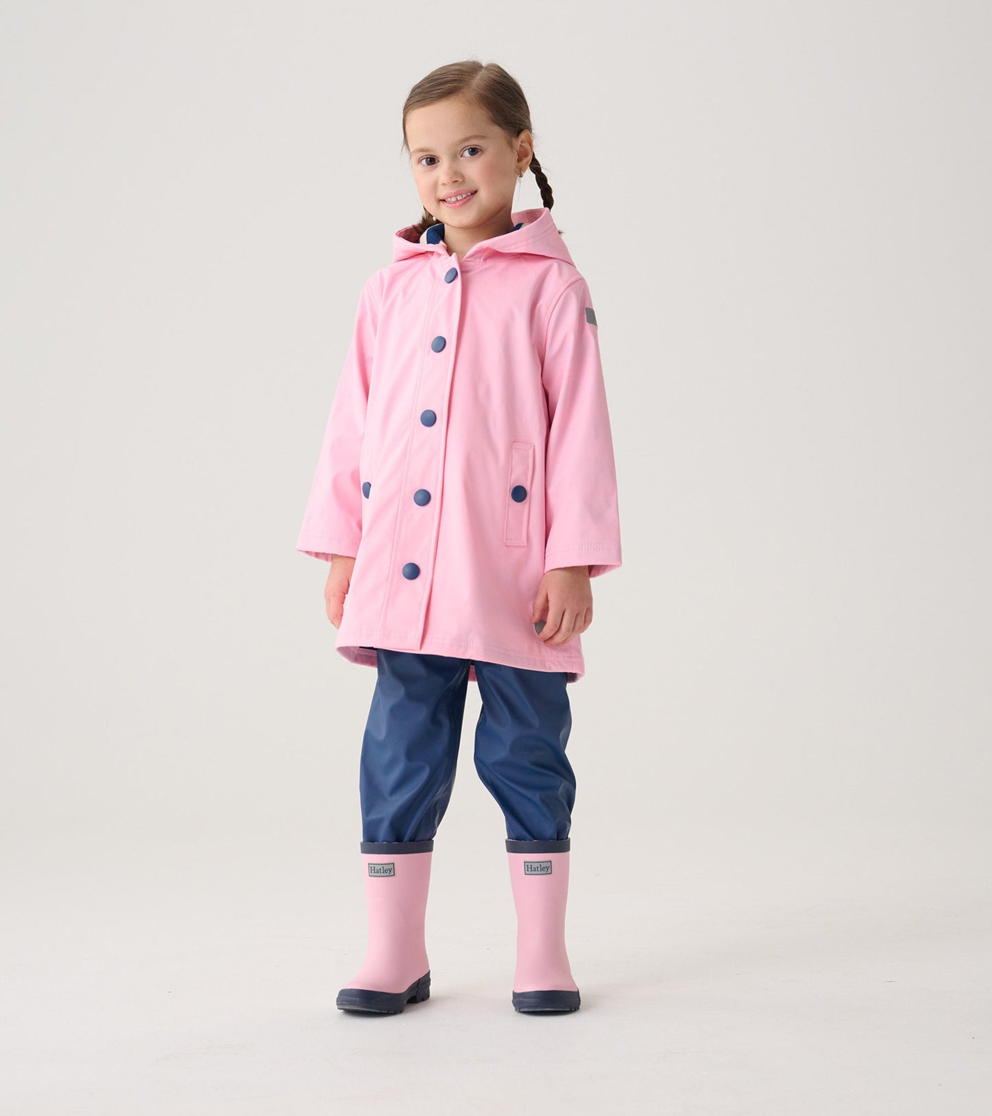 Kids' pink and navy matte rain boots with a rounded toe and a sturdy sole, perfect for wet weather.