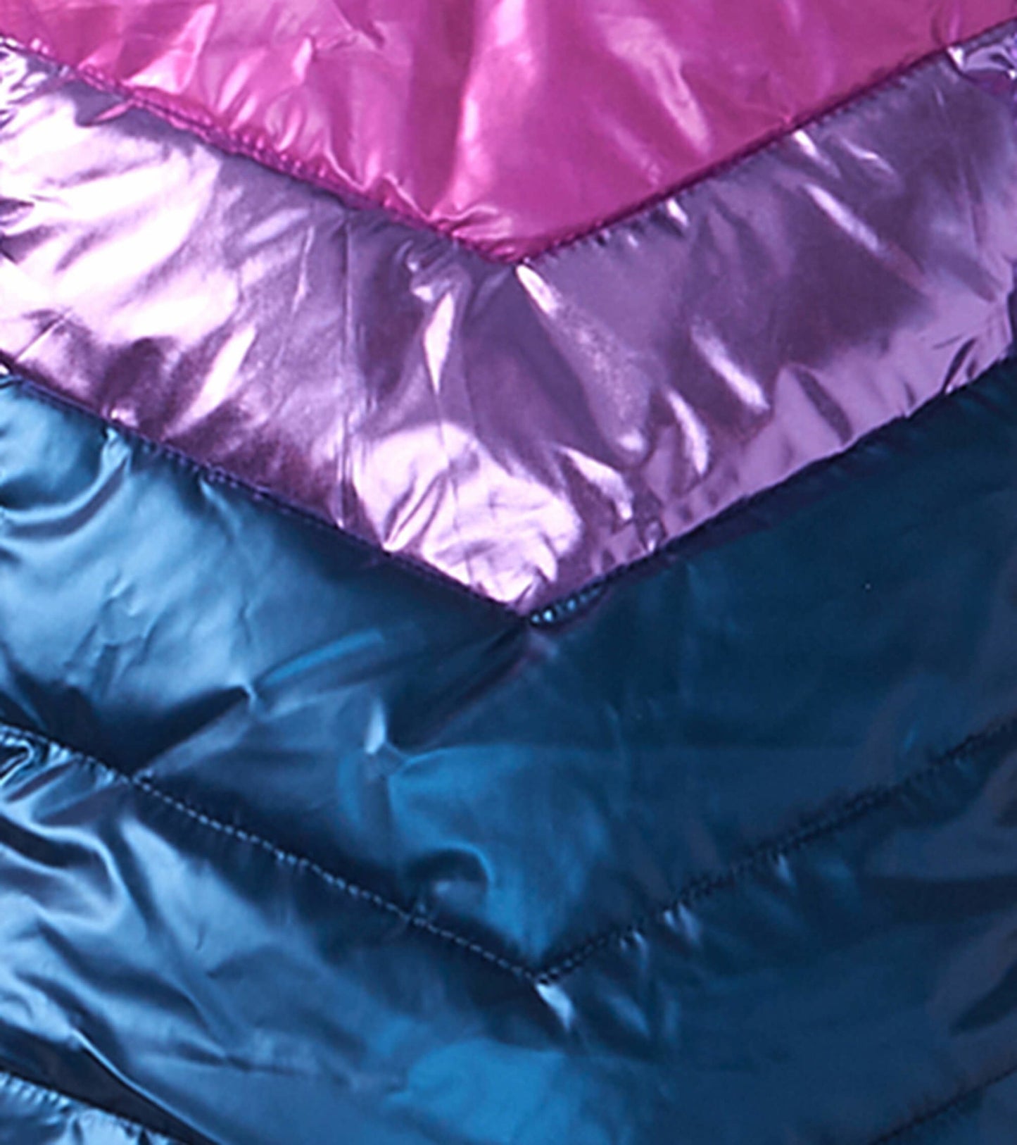 Colorful puffer jacket featuring chevron patterns in pink, purple, and teal, made from shiny, lightweight material.