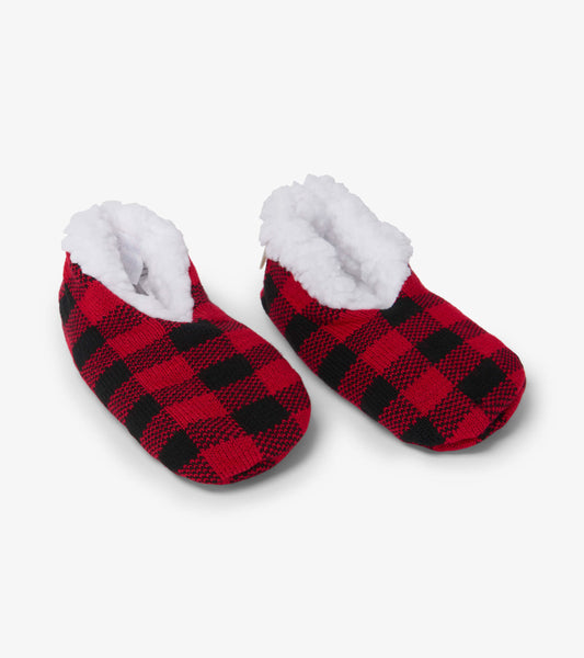 Red and black buffalo plaid kids' slippers with a soft white fleece lining for warmth and comfort.