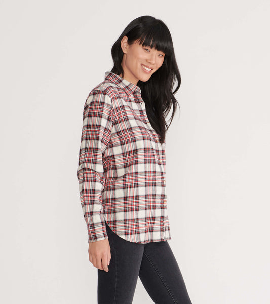 Cream plaid flannel shirt with red and black accents, featuring a button-up front and long sleeves, worn casually.