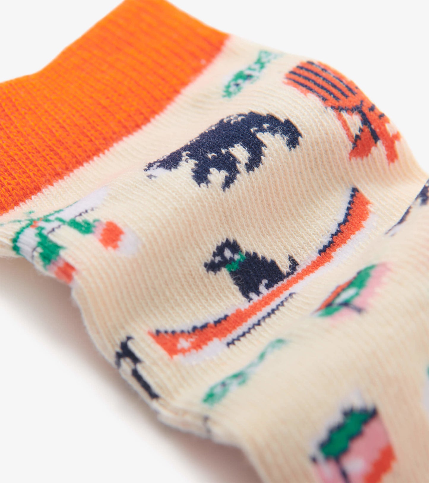 Cream crew socks featuring colorful lake-themed patterns, including bears, canoes, and trees, with an orange ribbed cuff.