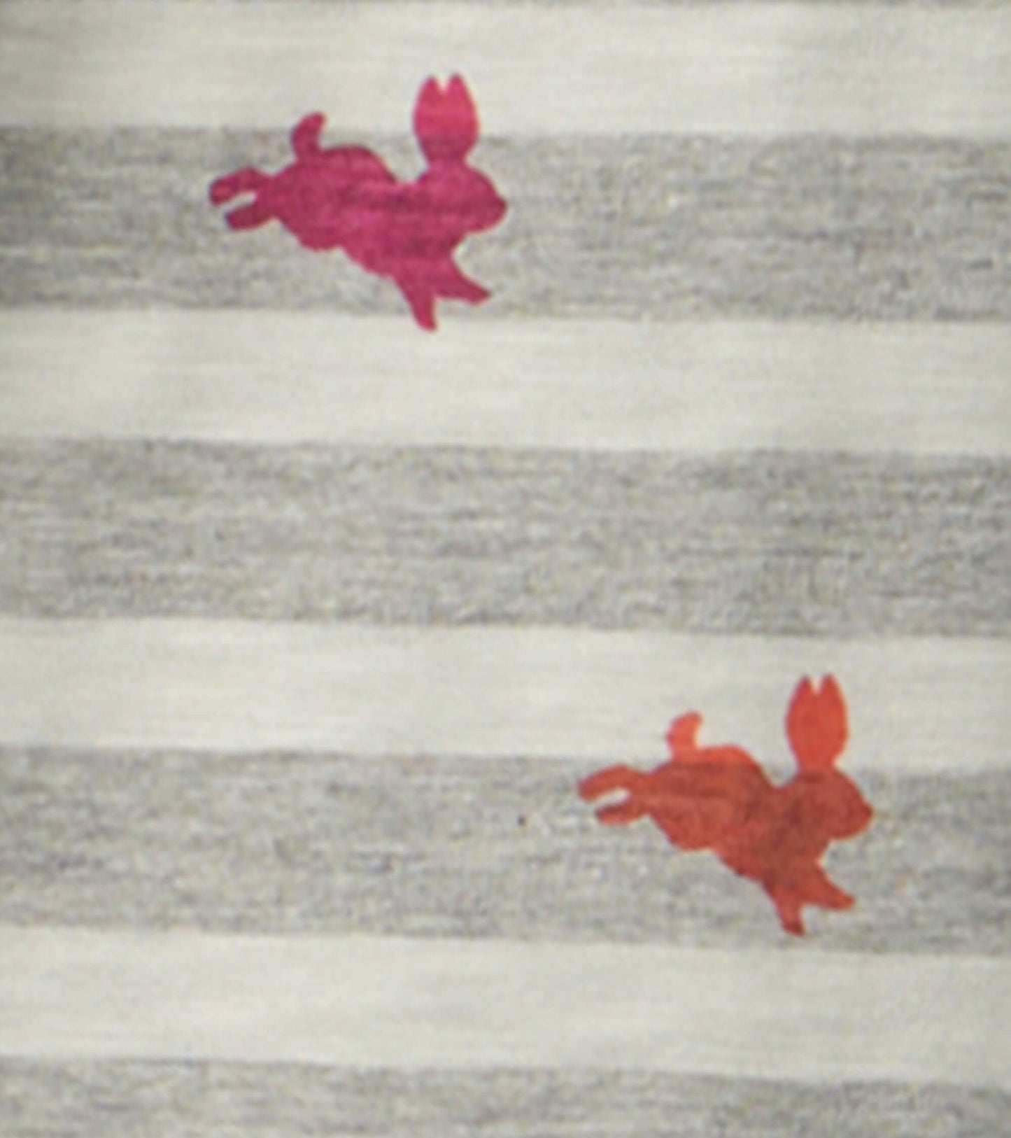 Tiered dress featuring gray and white stripes with playful pink and red bunny prints throughout.
