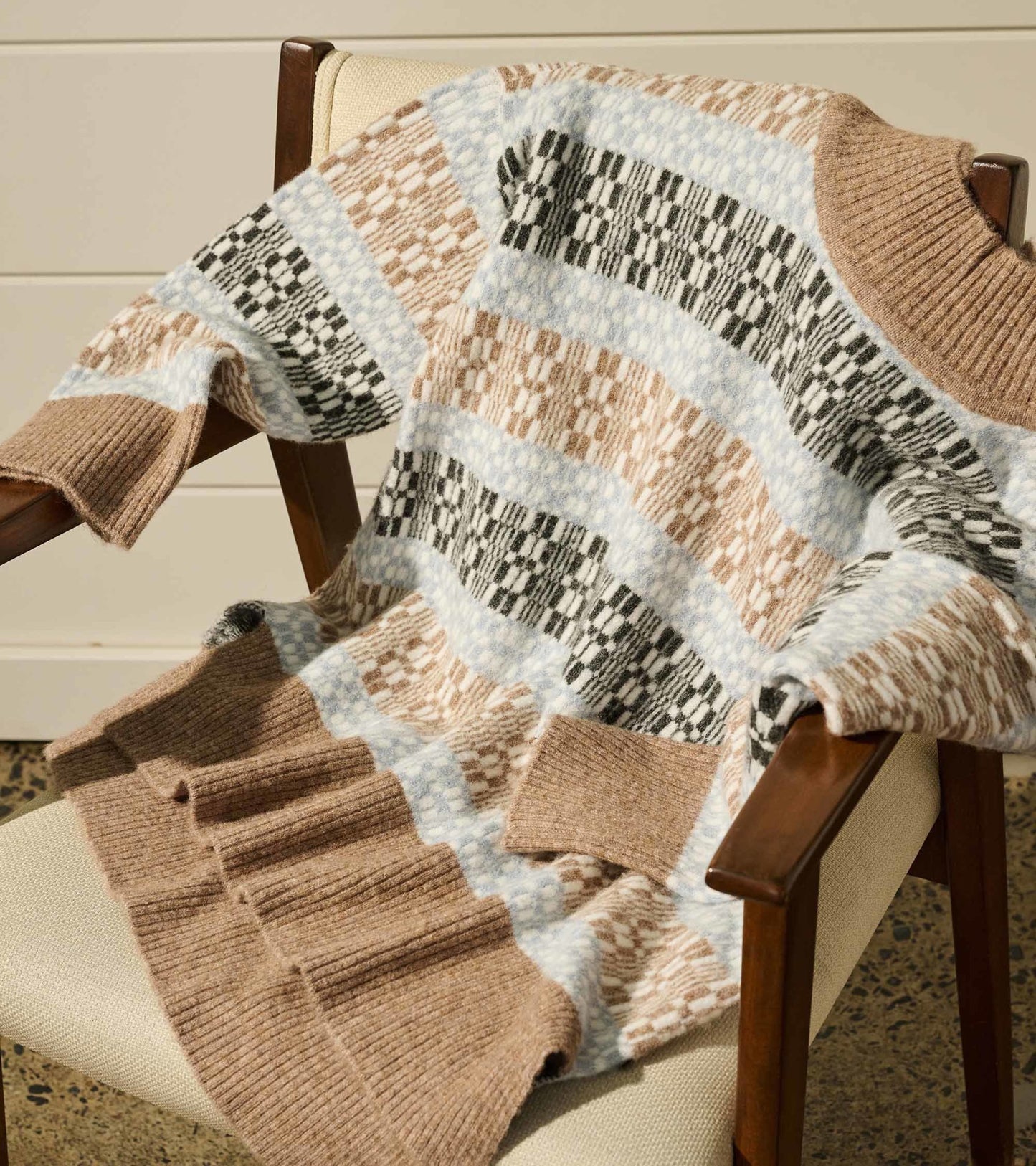 Mock neck sweater featuring a celestial plaid pattern in soft browns, blues, and blacks, with ribbed cuffs and hem.