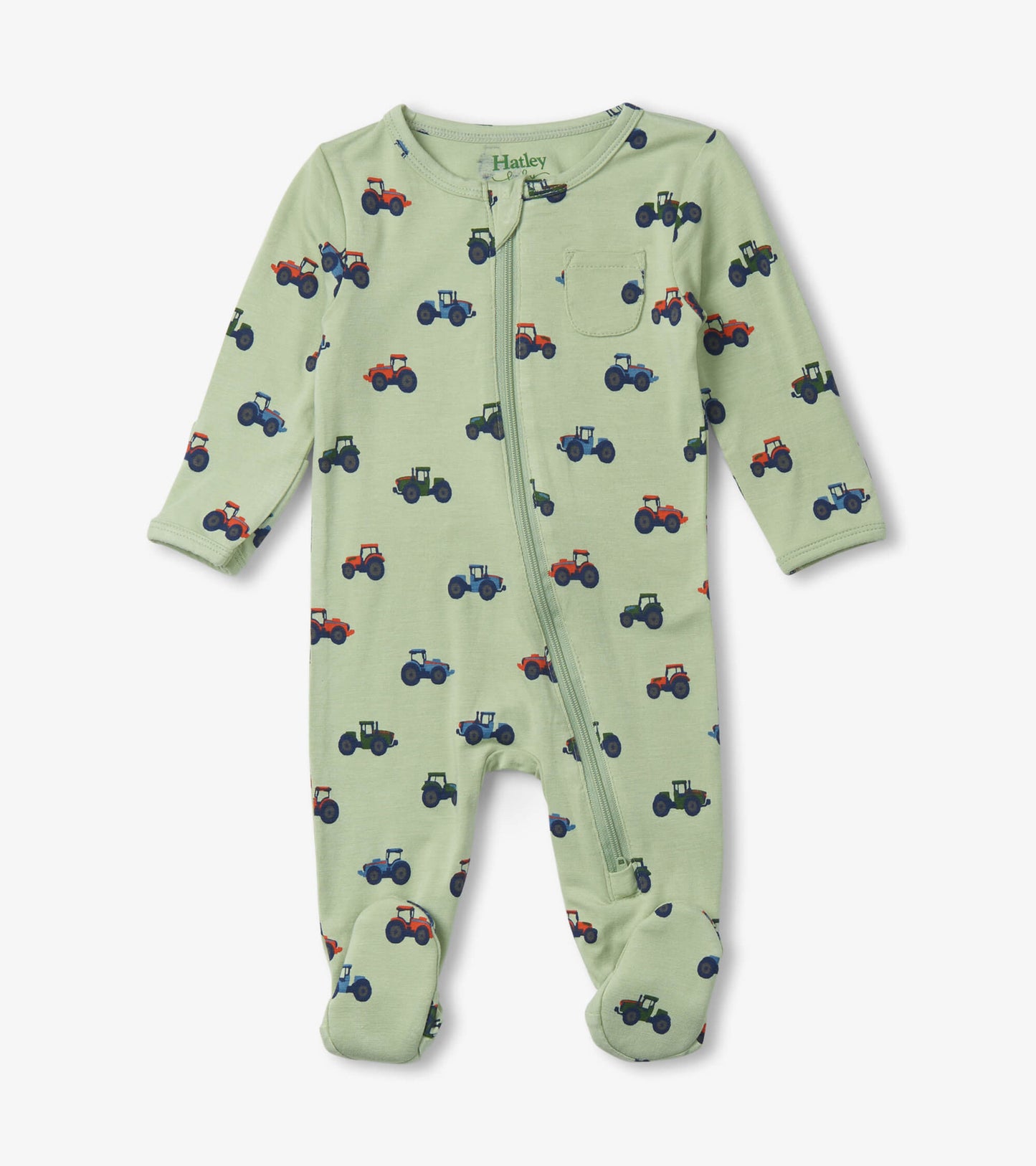 Light green zip-up footed sleeper featuring colorful tractor prints, designed for newborns with footed bottoms.