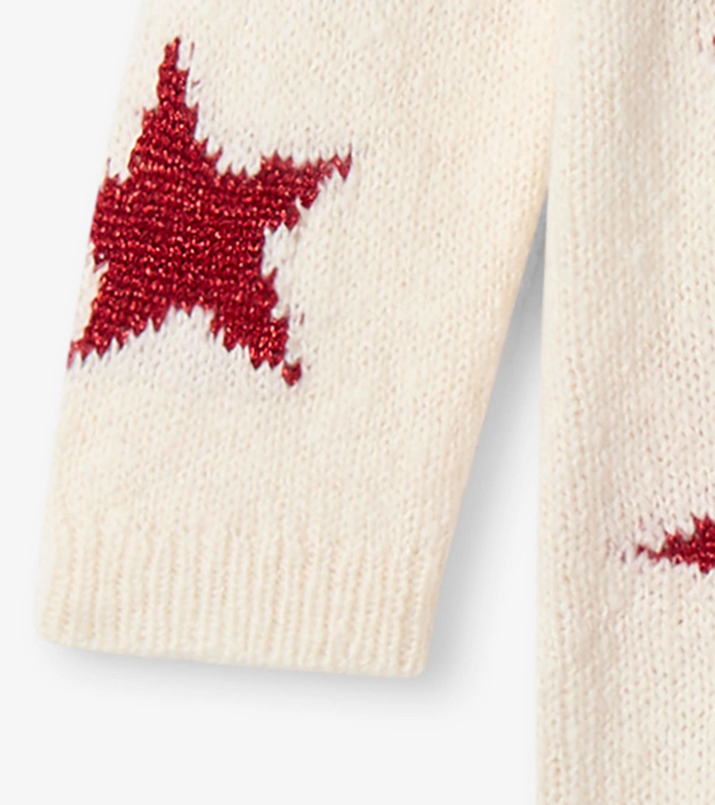 Cream sweater dress featuring red star patterns, perfect for festive occasions. Soft knit material for comfort.