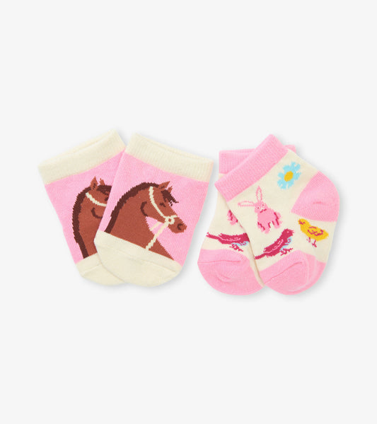 Two pairs of baby socks featuring a horse design and a colorful animal pattern on a pink background.