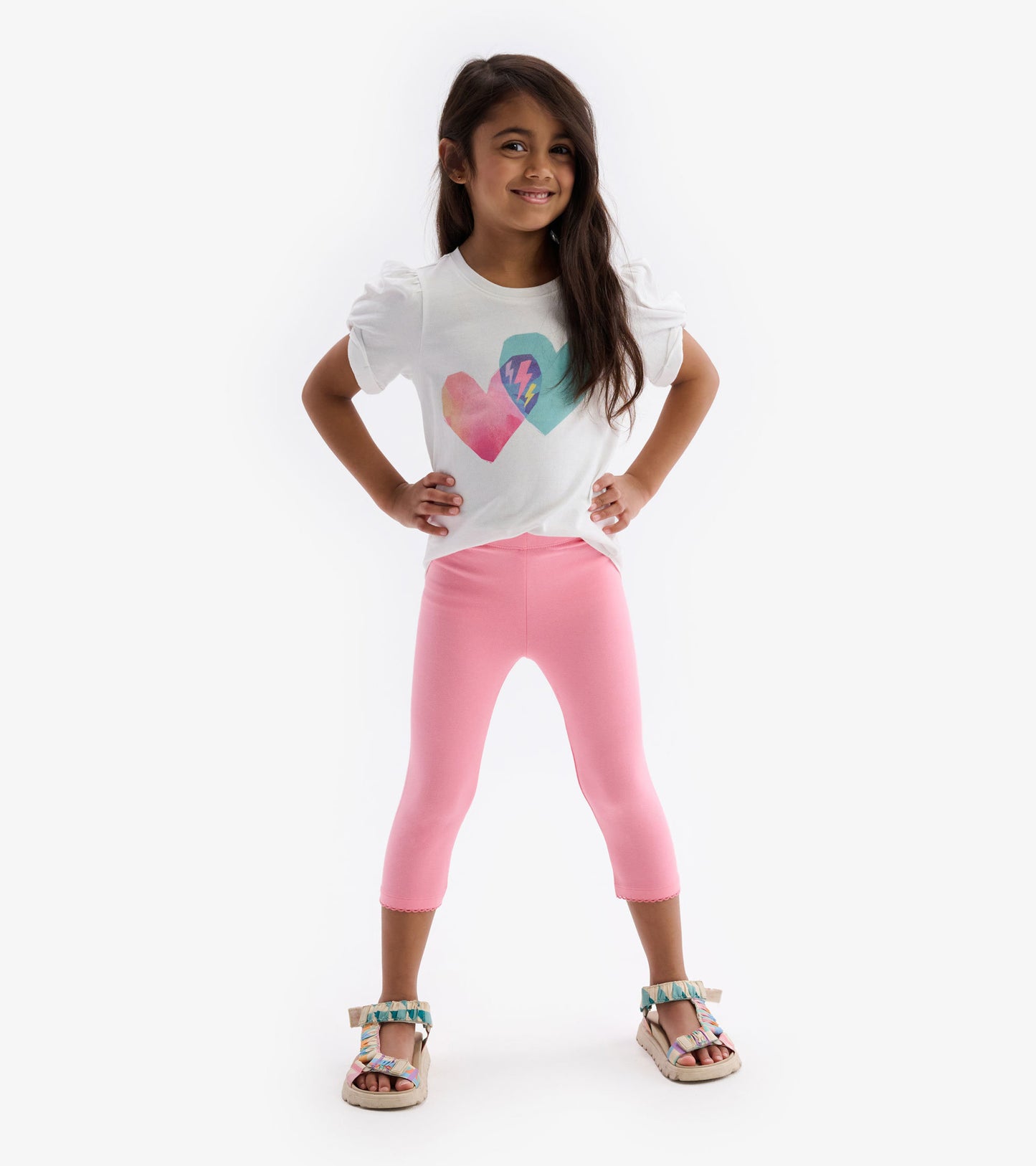 Light pink leggings with a fitted design, perfect for casual wear, paired with a white graphic tee and sandals.