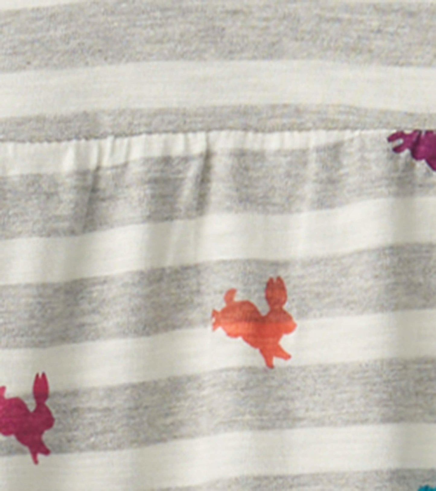 Gray and white striped tiered dress featuring colorful bunny prints in shades of pink and orange.