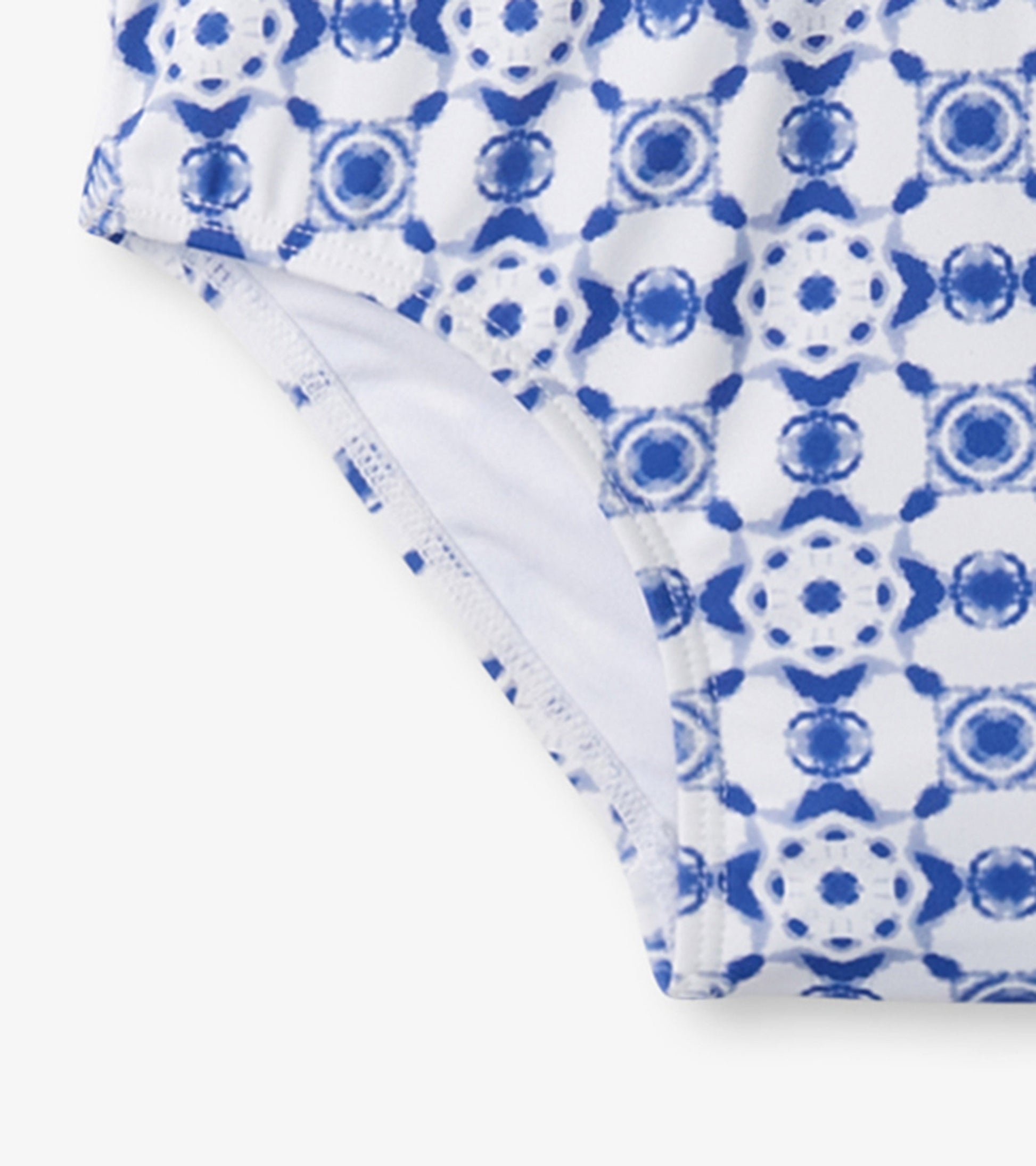 Blue and white kaleidoscope patterned one-piece rashguard for girls, featuring a snug fit and soft material.