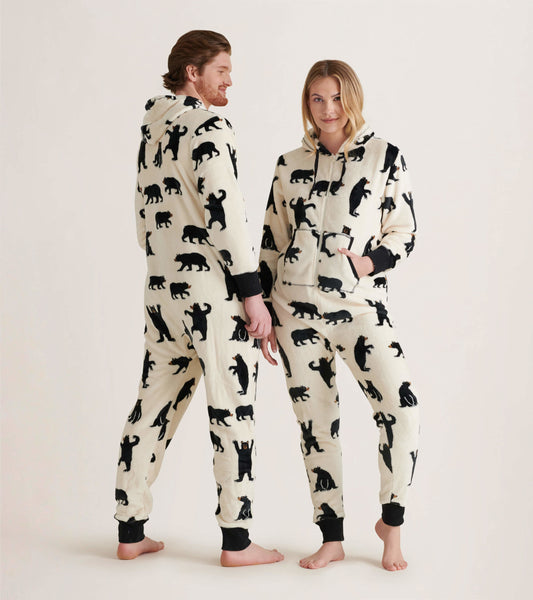 Hooded fleece jumpsuit in cream with black bear patterns, featuring a front pocket and ribbed cuffs.