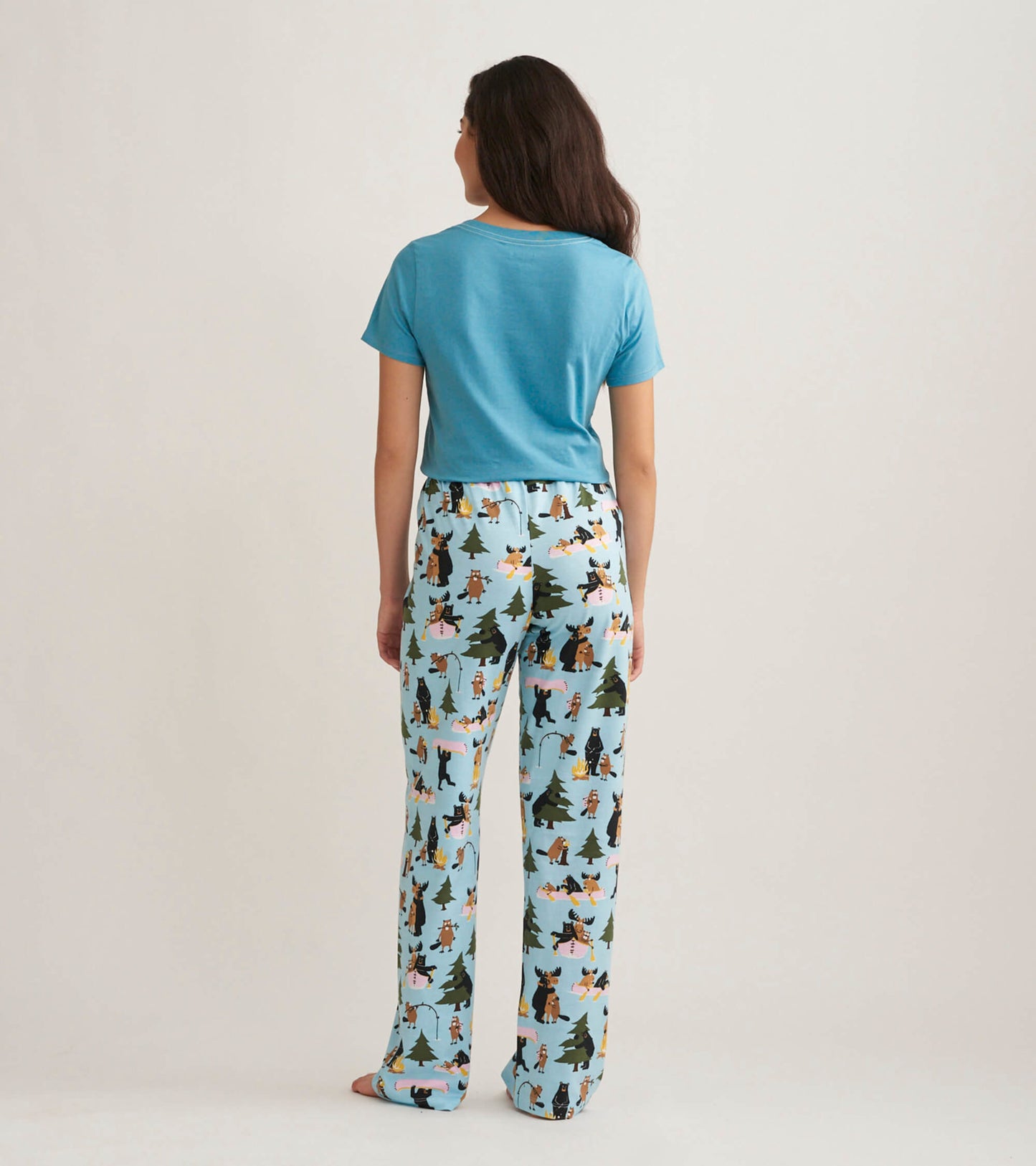Light blue pajama t-shirt paired with patterned pants featuring animals and trees, viewed from the back.
