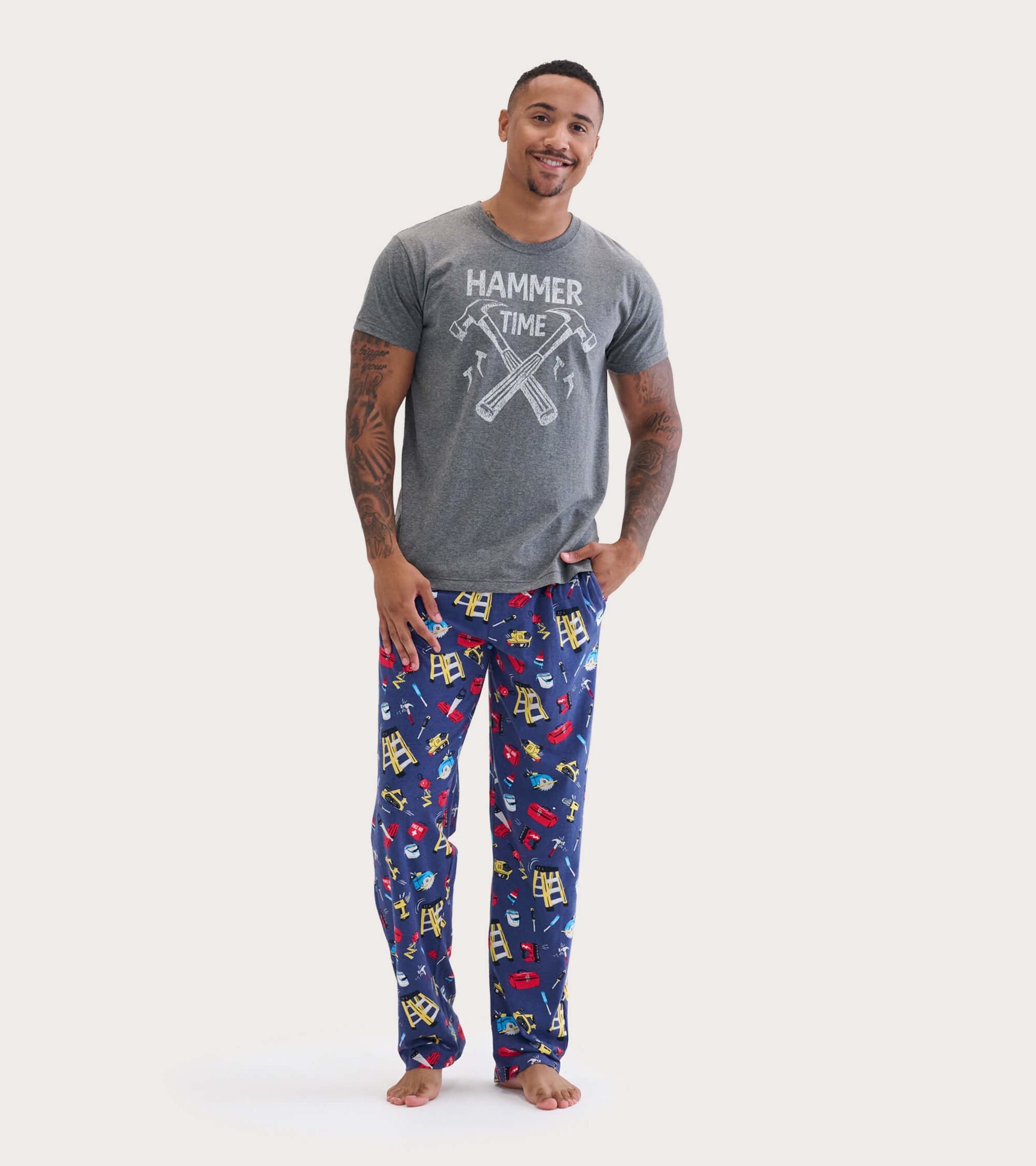 Gray short-sleeve tee featuring a "Hammer Time" graphic, paired with colorful pajama pants with tool patterns.