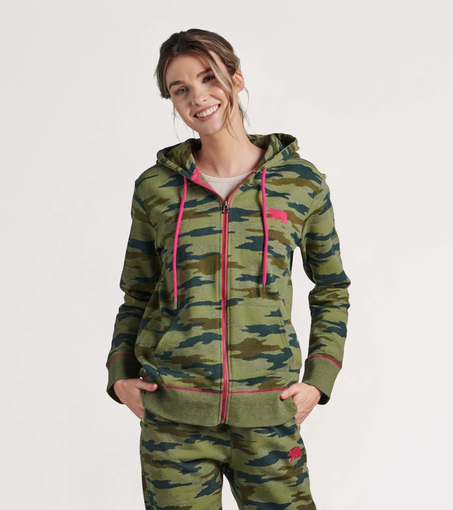 Woodland camo full zip hoodie with pink drawstrings, featuring a relaxed fit and front pockets.
