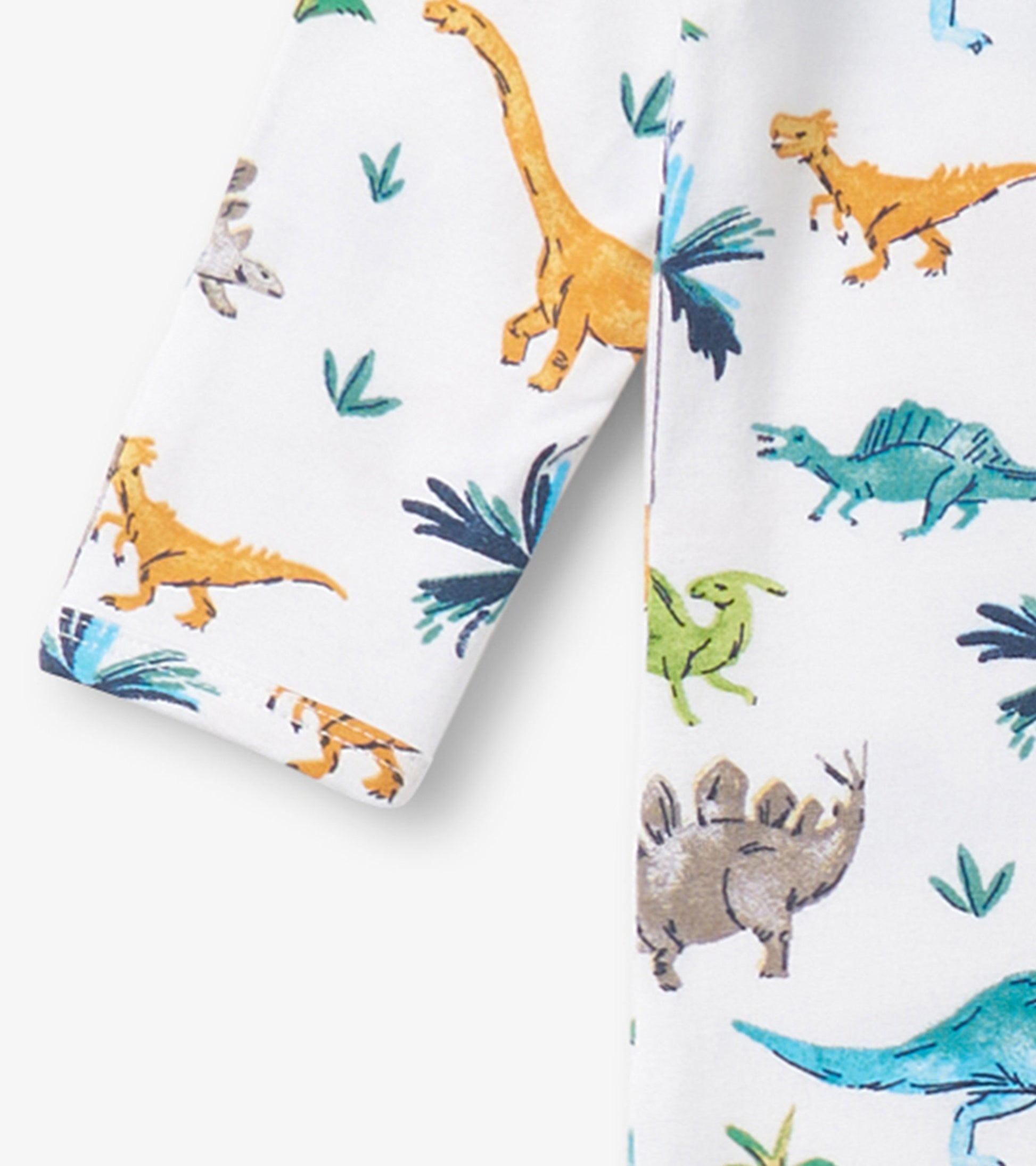 White footed sleeper featuring colorful dinosaur prints and green foliage, suitable for baby boys.