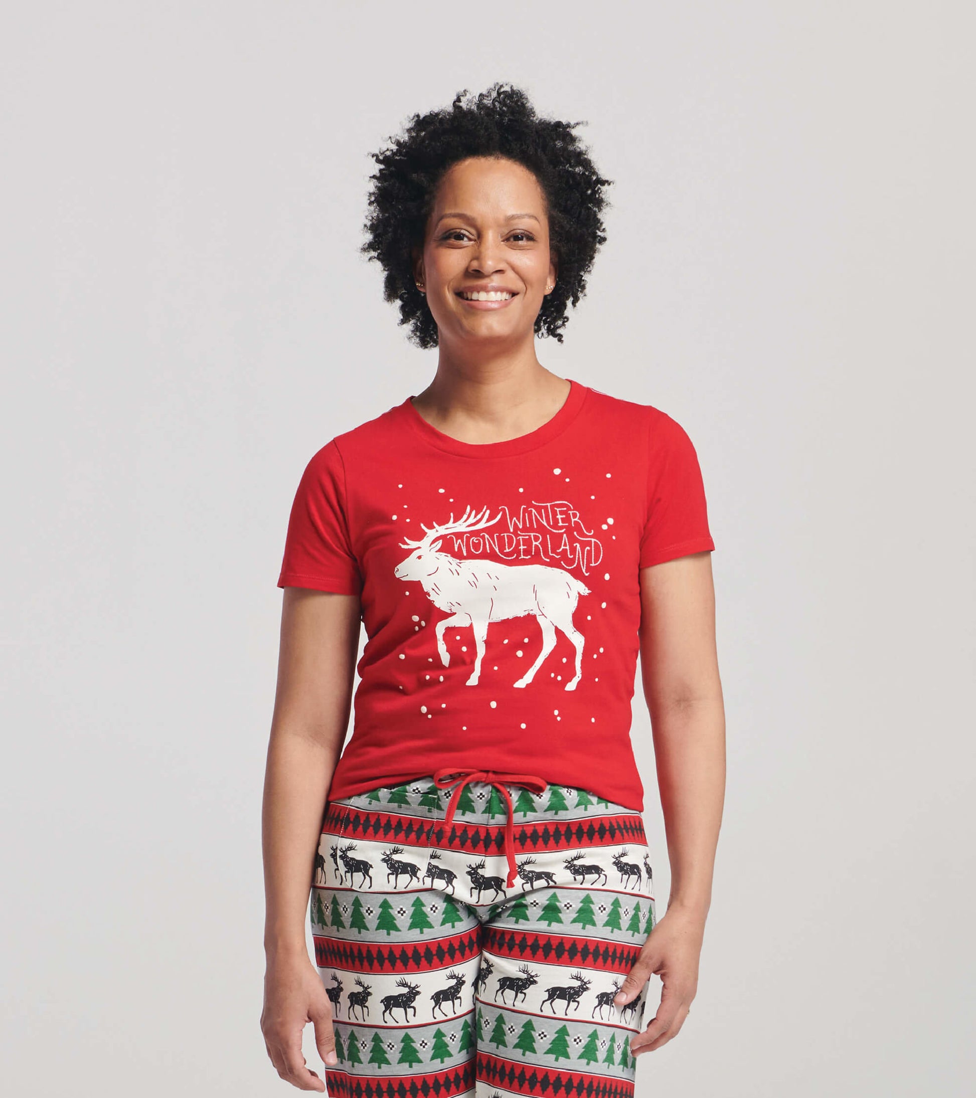 Red short sleeve t-shirt featuring a white moose graphic and "WINTER WONDERLAND" text, styled for a casual look.
