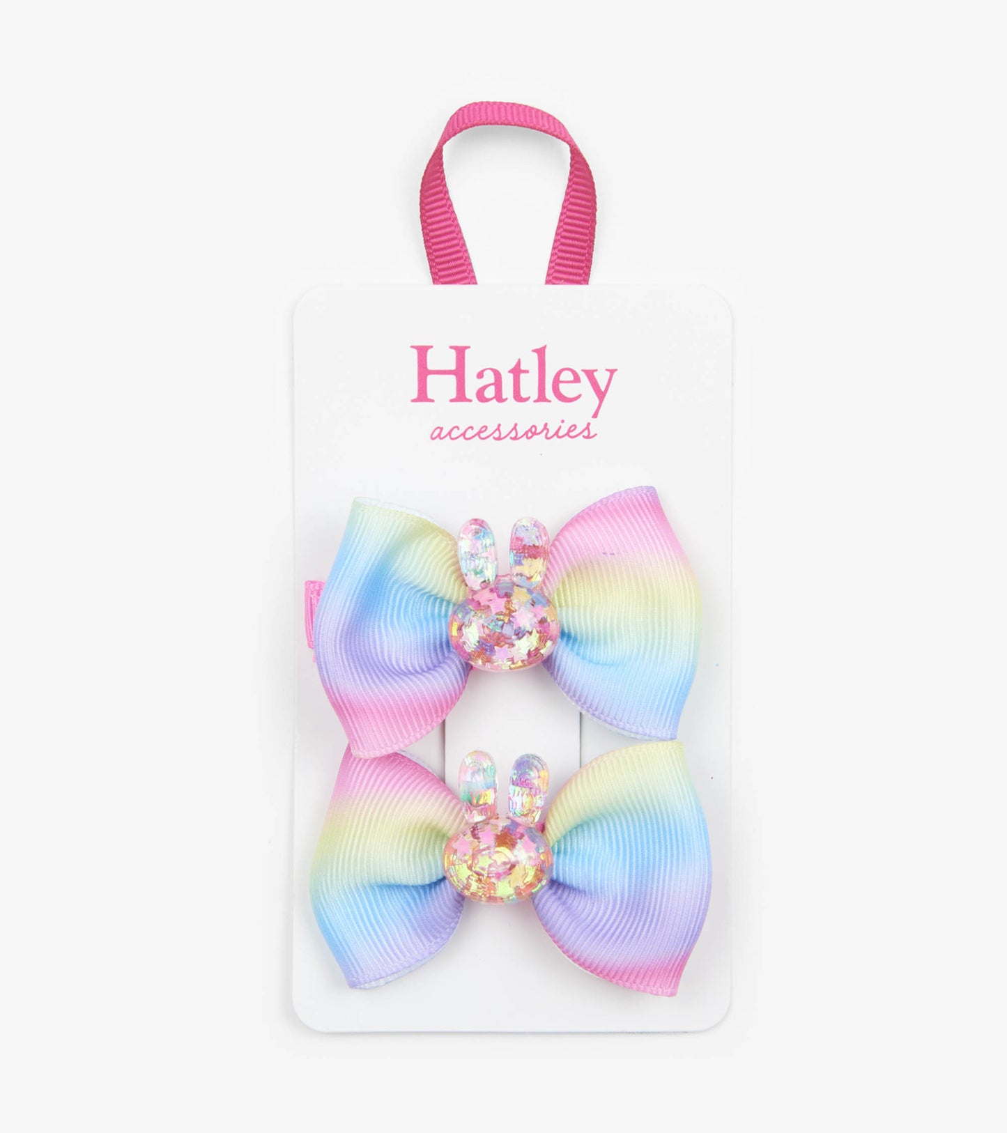 Pastel rainbow hair clips featuring glittery bunny accents, perfect for securing hair in playful styles.