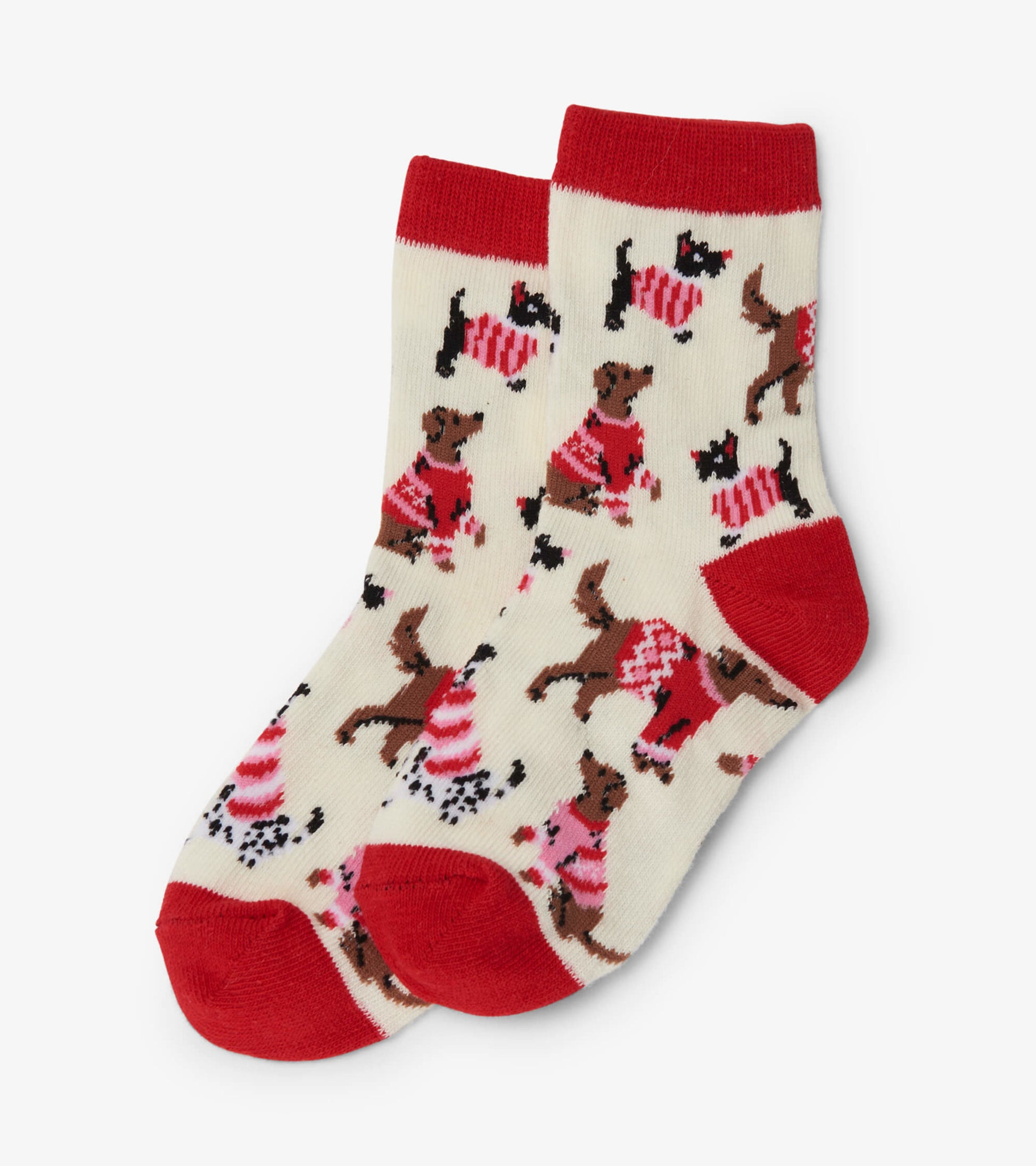 Cream socks featuring playful dogs in festive sweaters, with red cuffs and toes, suitable for kids ages 2-7.