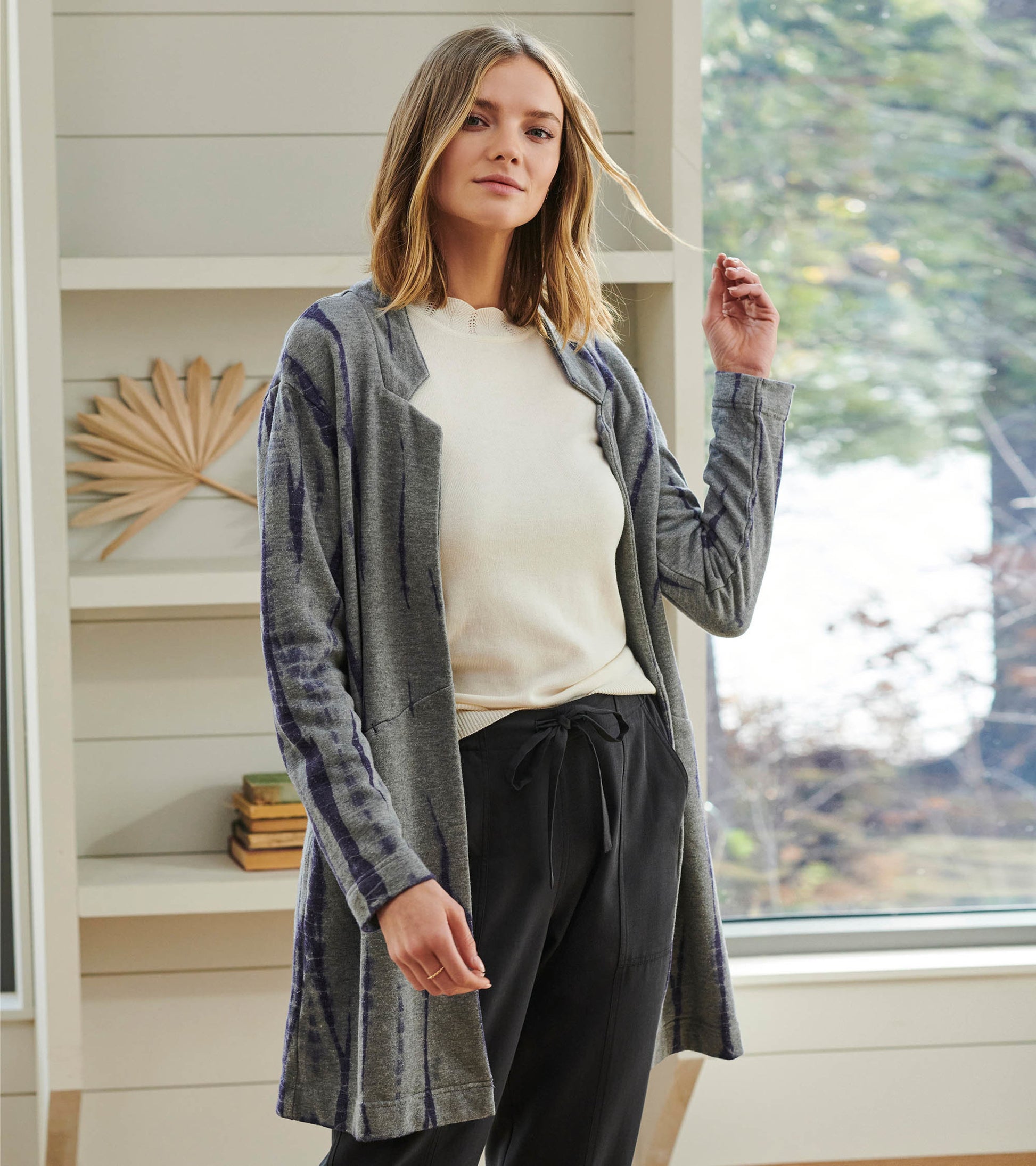 Long gray cardigan with storm tie-dye pattern, open front, worn over a light sweater and black pants.