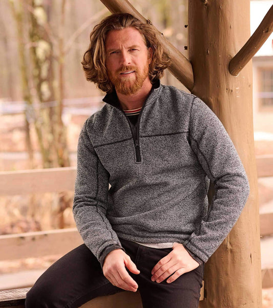 Grey mock neck pullover with a sherpa lining, featuring a zippered front and long sleeves, worn by a man outdoors.
