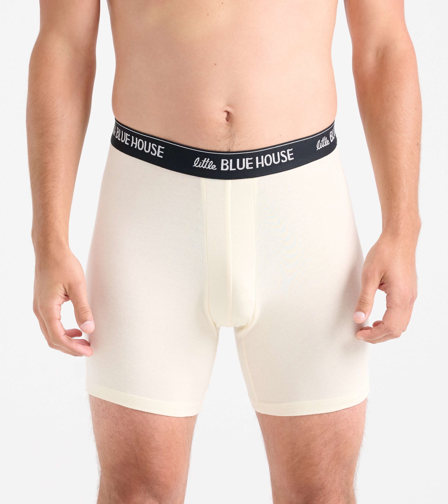 Men's boxer briefs in light cream with a black waistband, featuring a snug fit and soft material.