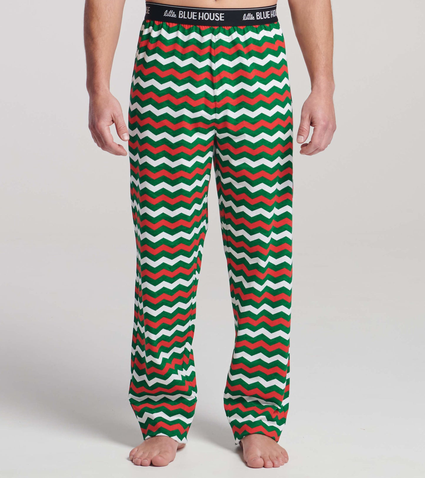 Men's pajama pants in a festive zig-zag pattern with red, green, and white colors, made of stretch cotton.