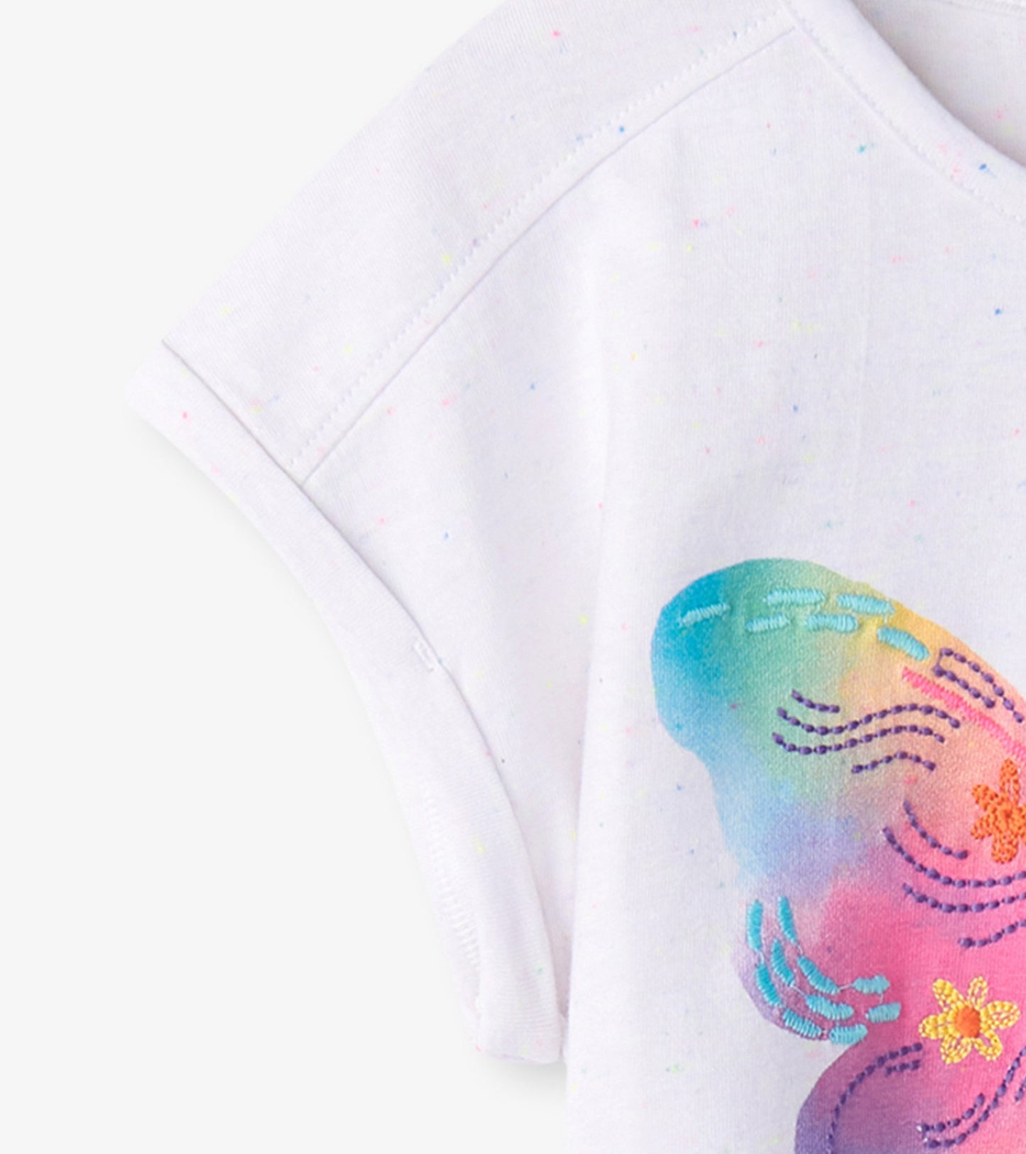 White relaxed t-shirt featuring a colorful painted butterfly design with pastel hues and floral accents.