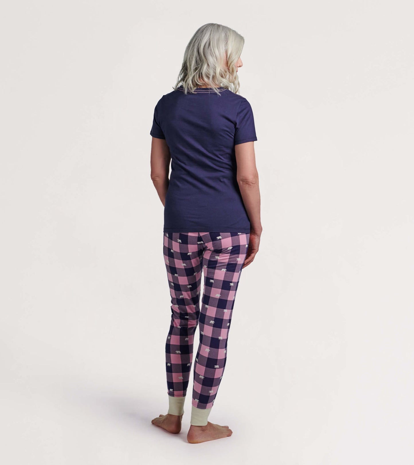 Navy short-sleeve pajama t-shirt paired with pink and navy checkered pajama pants featuring bear prints.