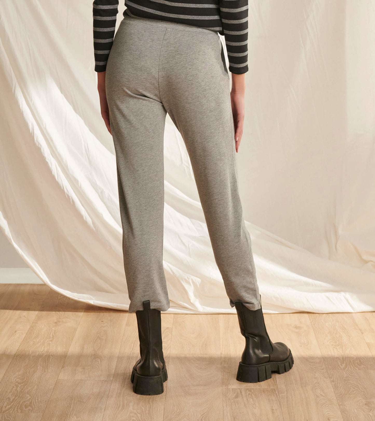 Charcoal melange joggers with a relaxed fit, featuring a tapered leg and side slits, styled with black ankle boots.