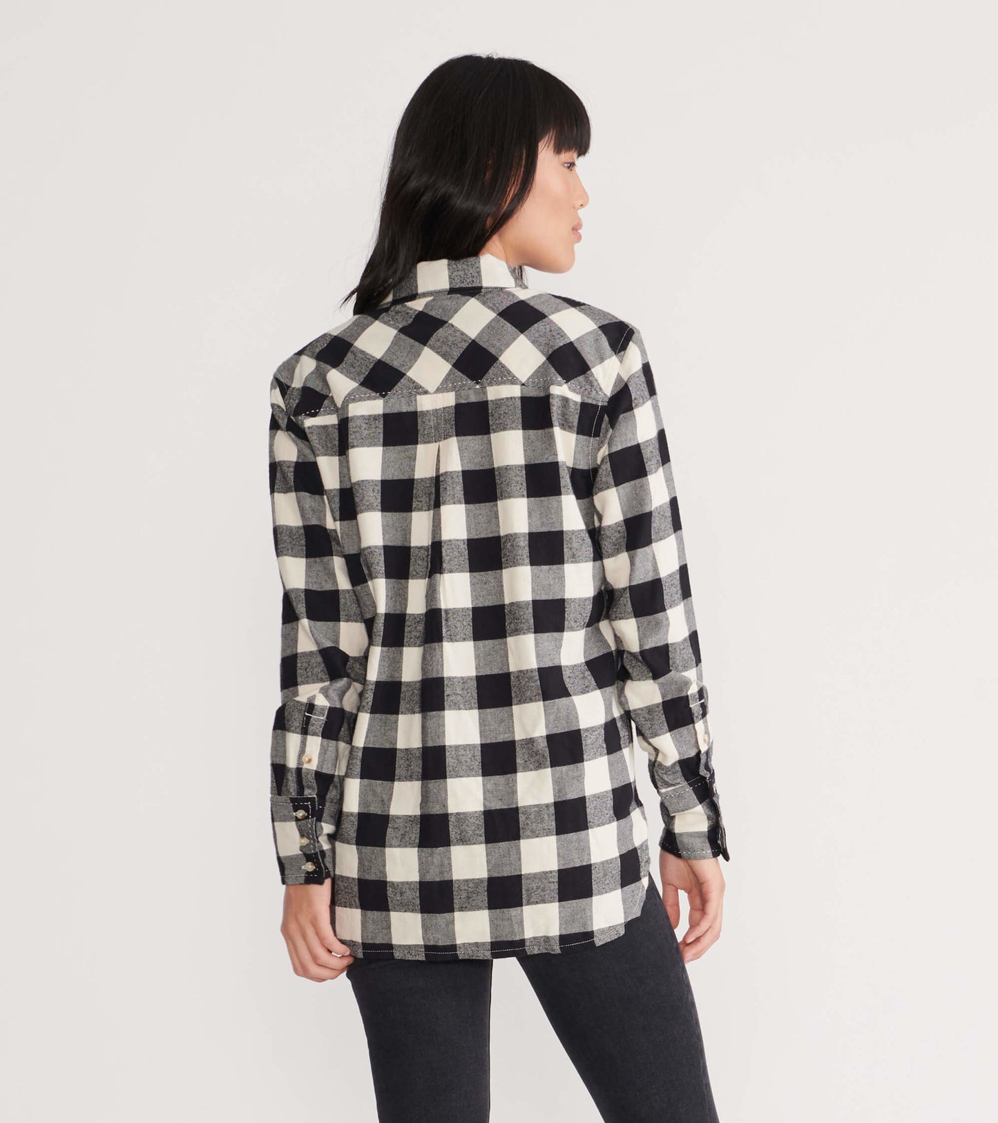 Black and white plaid flannel shirt with long sleeves and a relaxed fit, shown from the back.