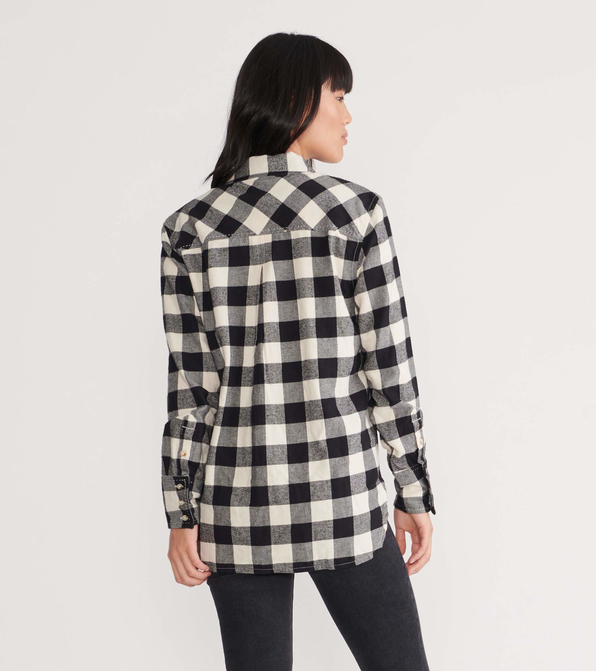 Black and white plaid flannel shirt with long sleeves and a relaxed fit, shown from the back.