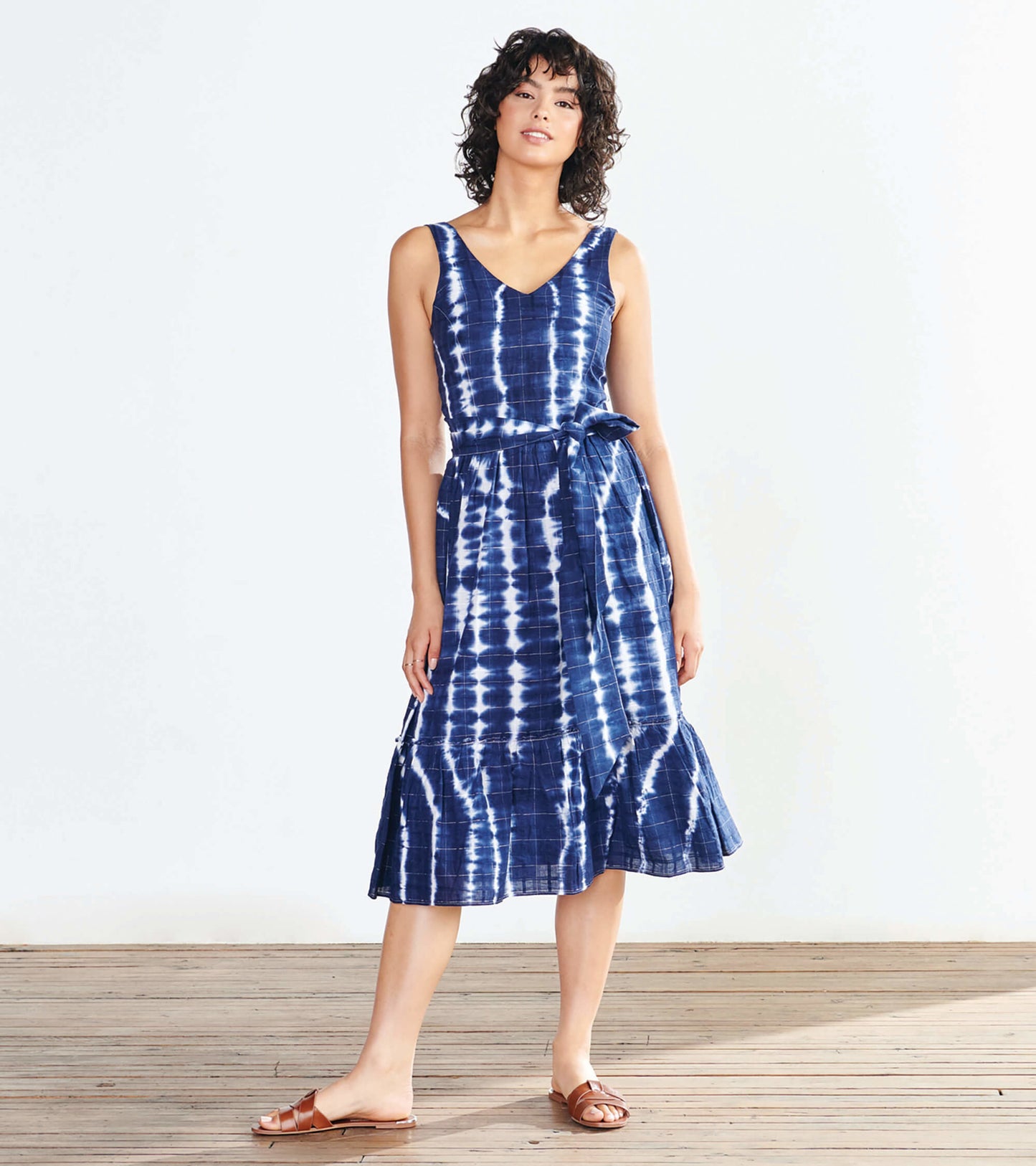 Navy blue midi dress with a tie waist, featuring a tie-dye pattern and a flared hem, perfect for casual wear.