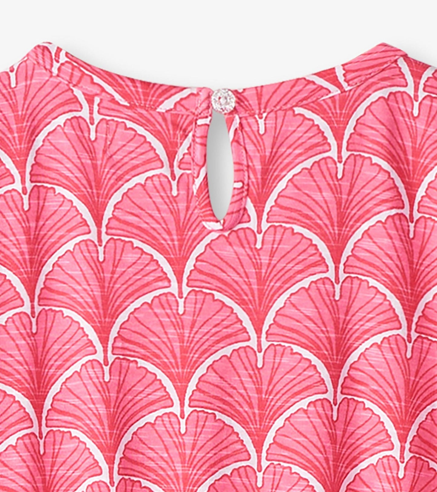Coral T-shirt dress featuring a fan pattern and a keyhole back with a button closure.