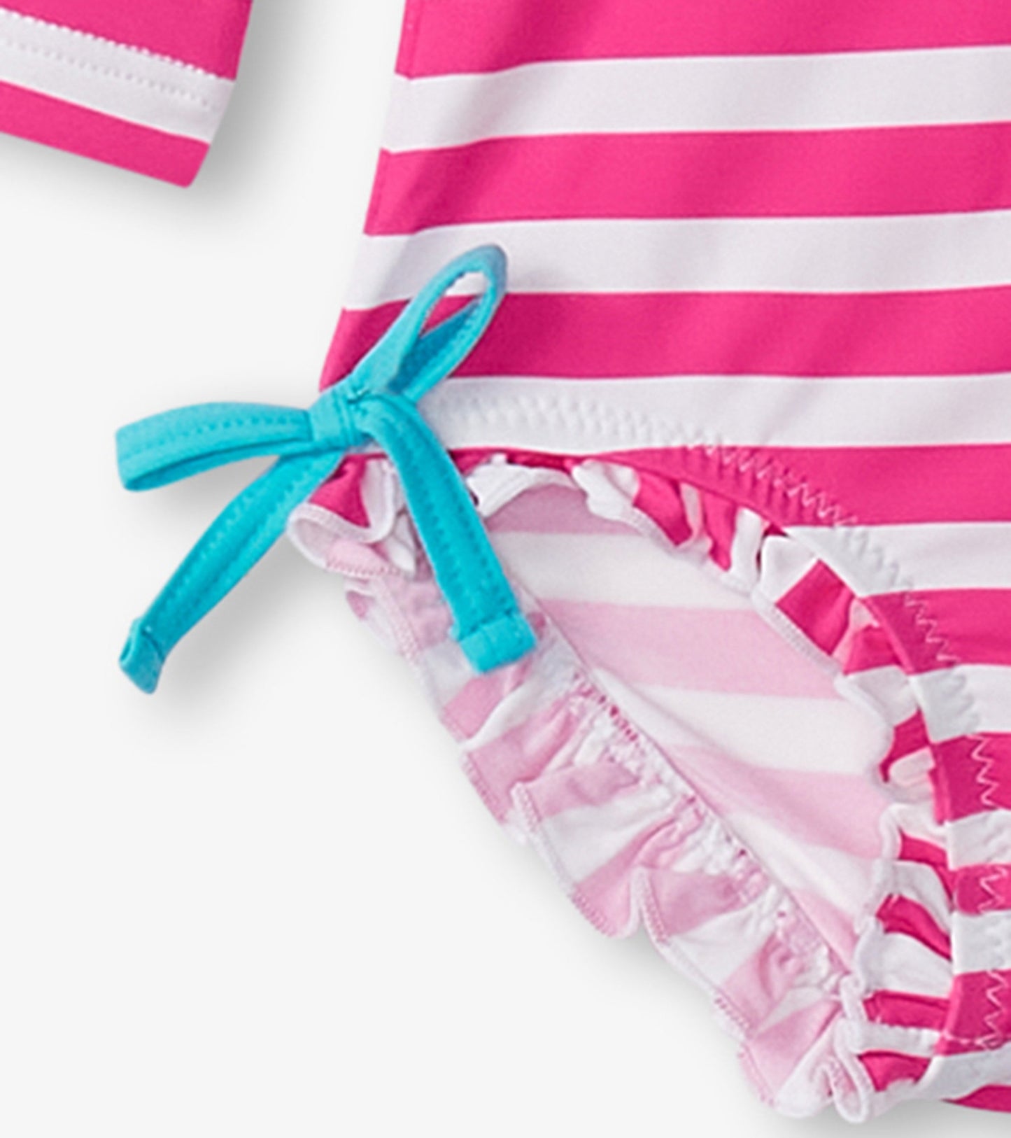 Pink and white striped rashguard swimsuit with ruffled edges and a turquoise tie detail. Suitable for baby girls.